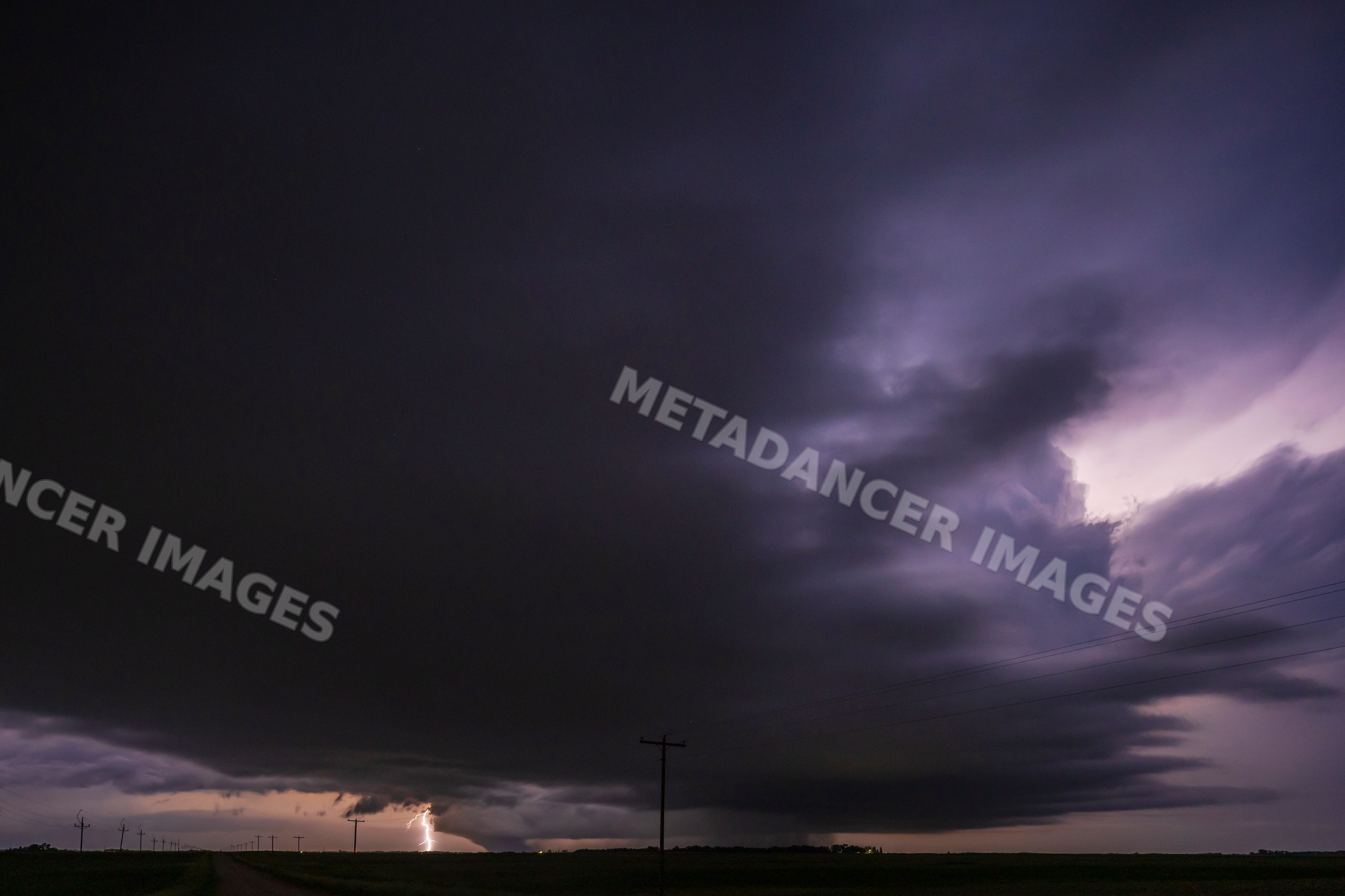 Wedge Tornado touches down under a dark Supercell with Lightning