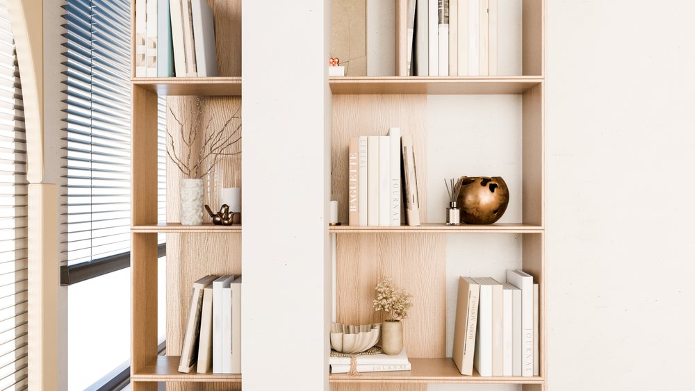 Bookshelf with books and minimalist decor by window blinds