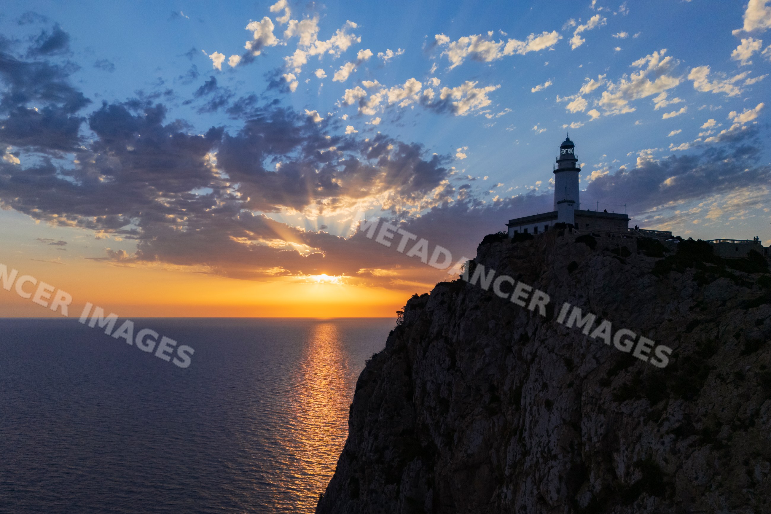 Far de Formentor Lighthouse at sunrise on cliff in Mallorca Spain