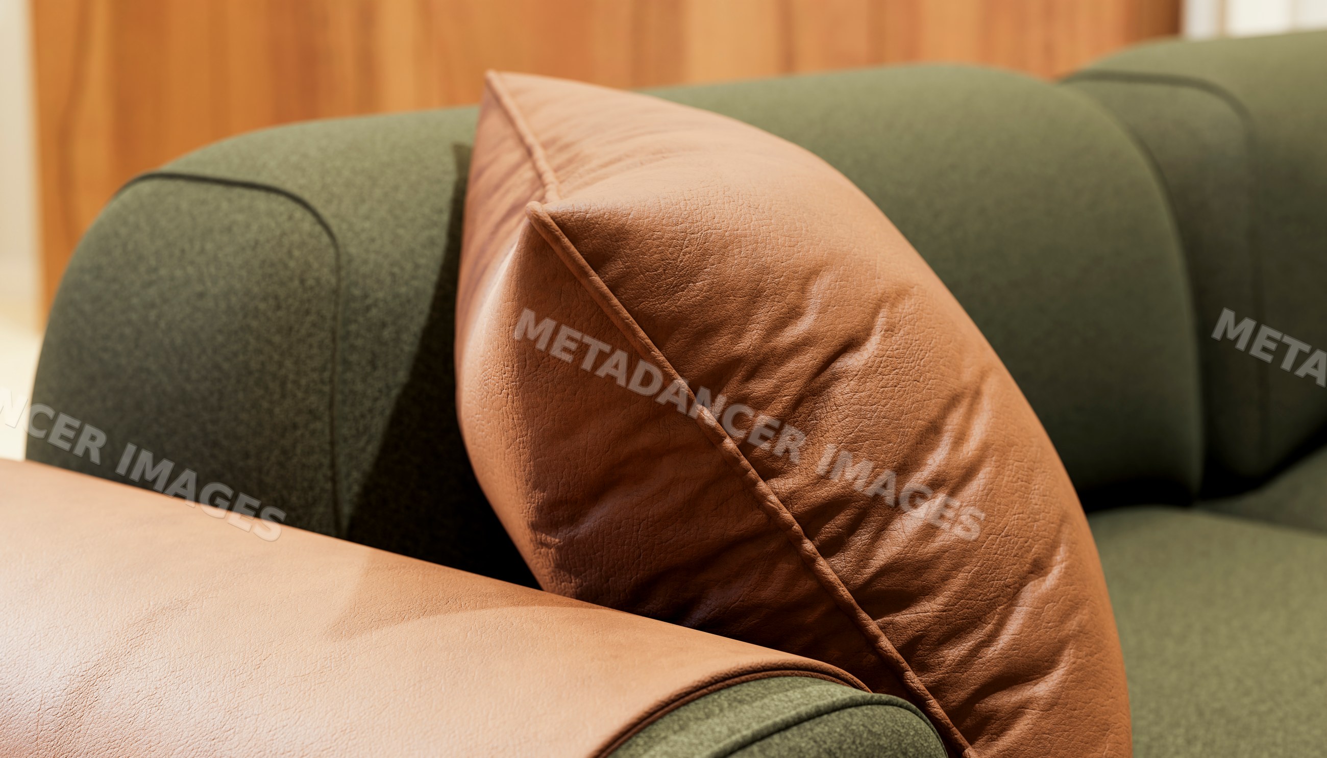 Brown leather pillow on green fabric sofa armrest indoors