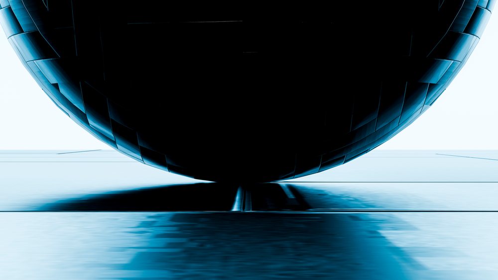Abstract curved metallic sculpture with blue reflections in gallery