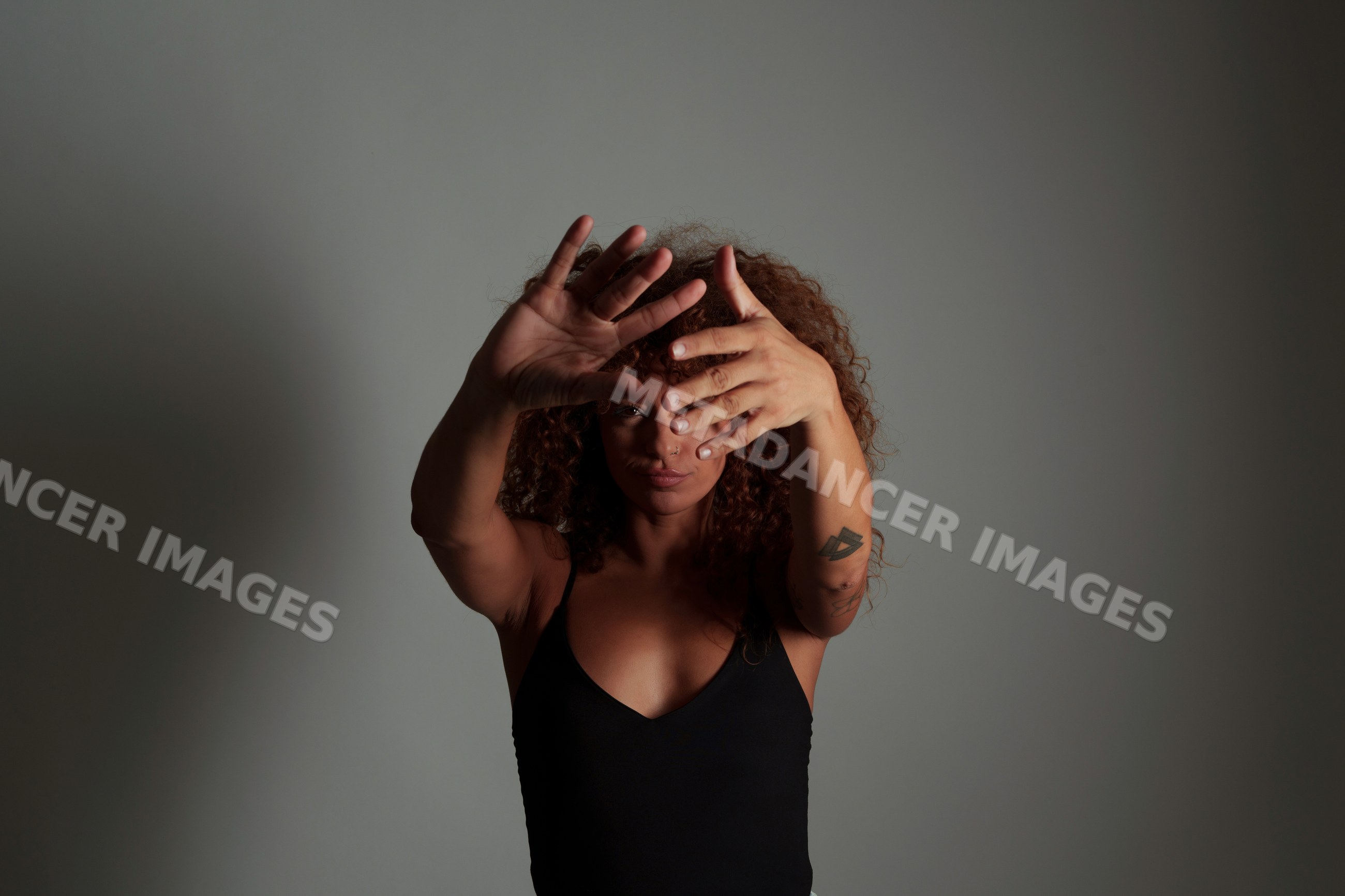 Hispanic woman with curly red hair posing in studio in Malaga, Spain