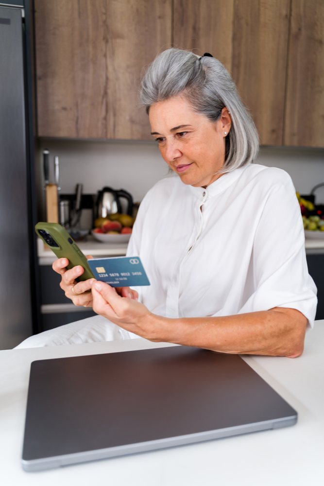 White Woman making an online payment with credit card and smartphone