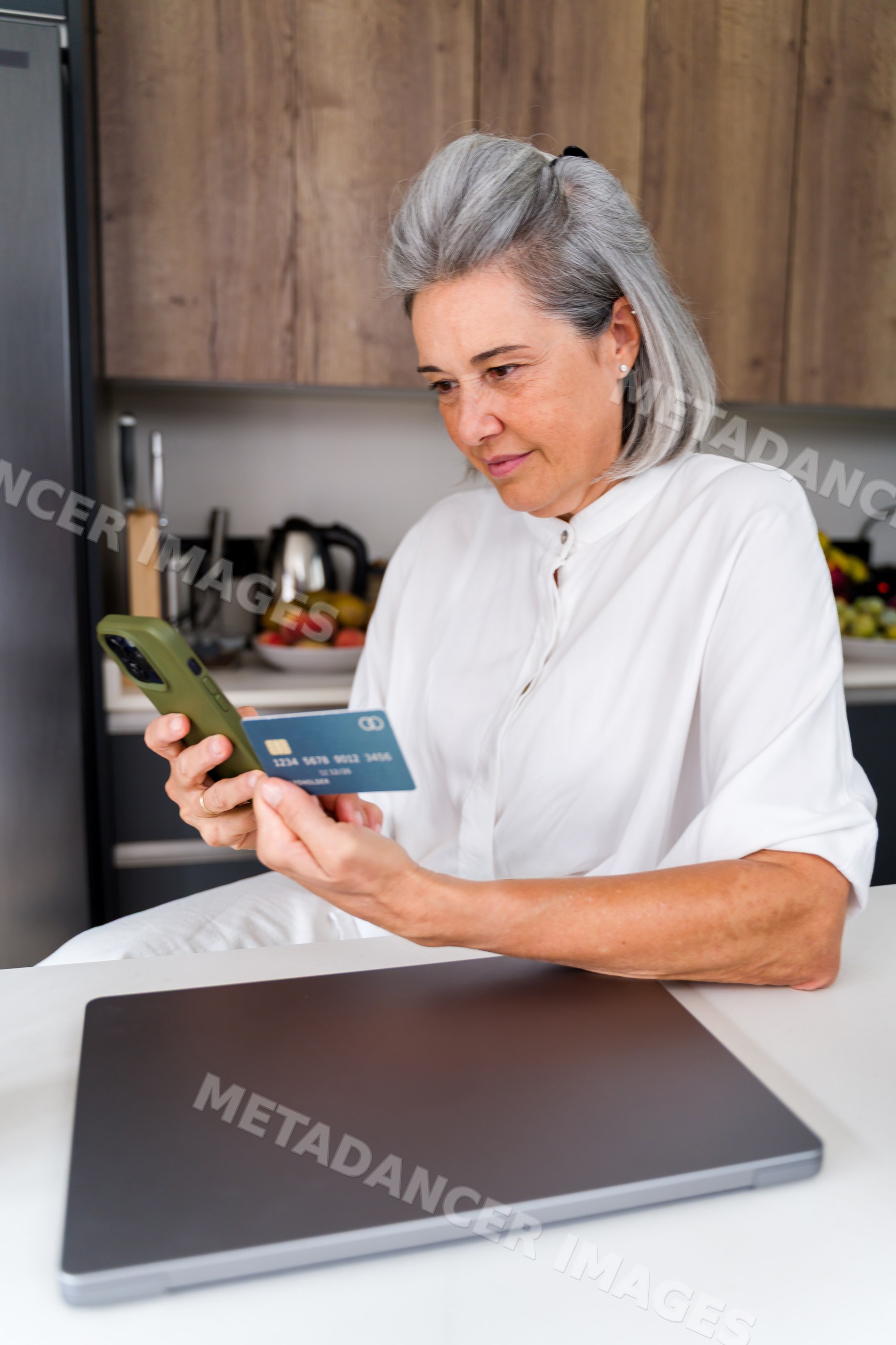White Woman making an online payment with credit card and smartphone