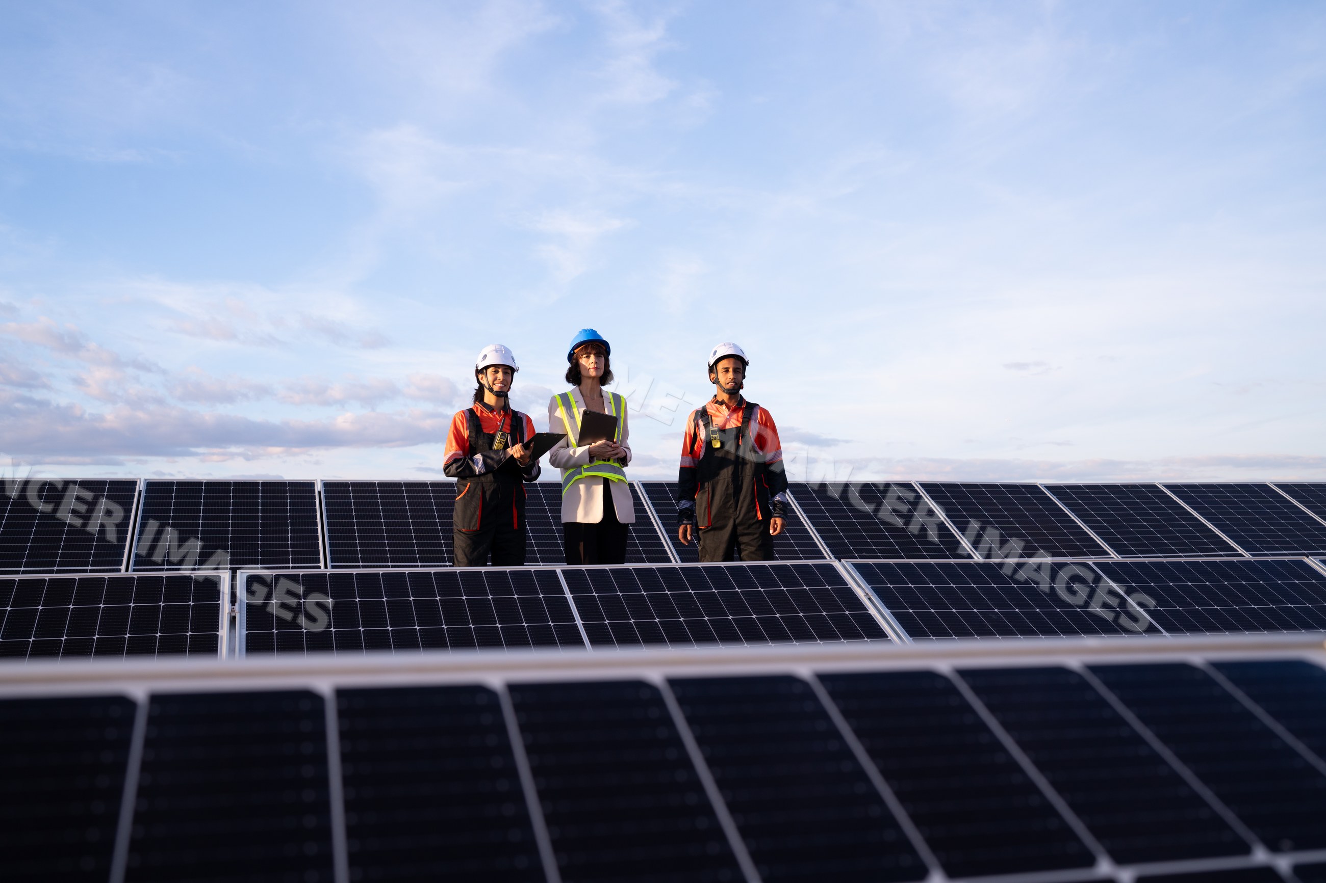 Engineers inspecting solar panels at solar power plant in Madrid