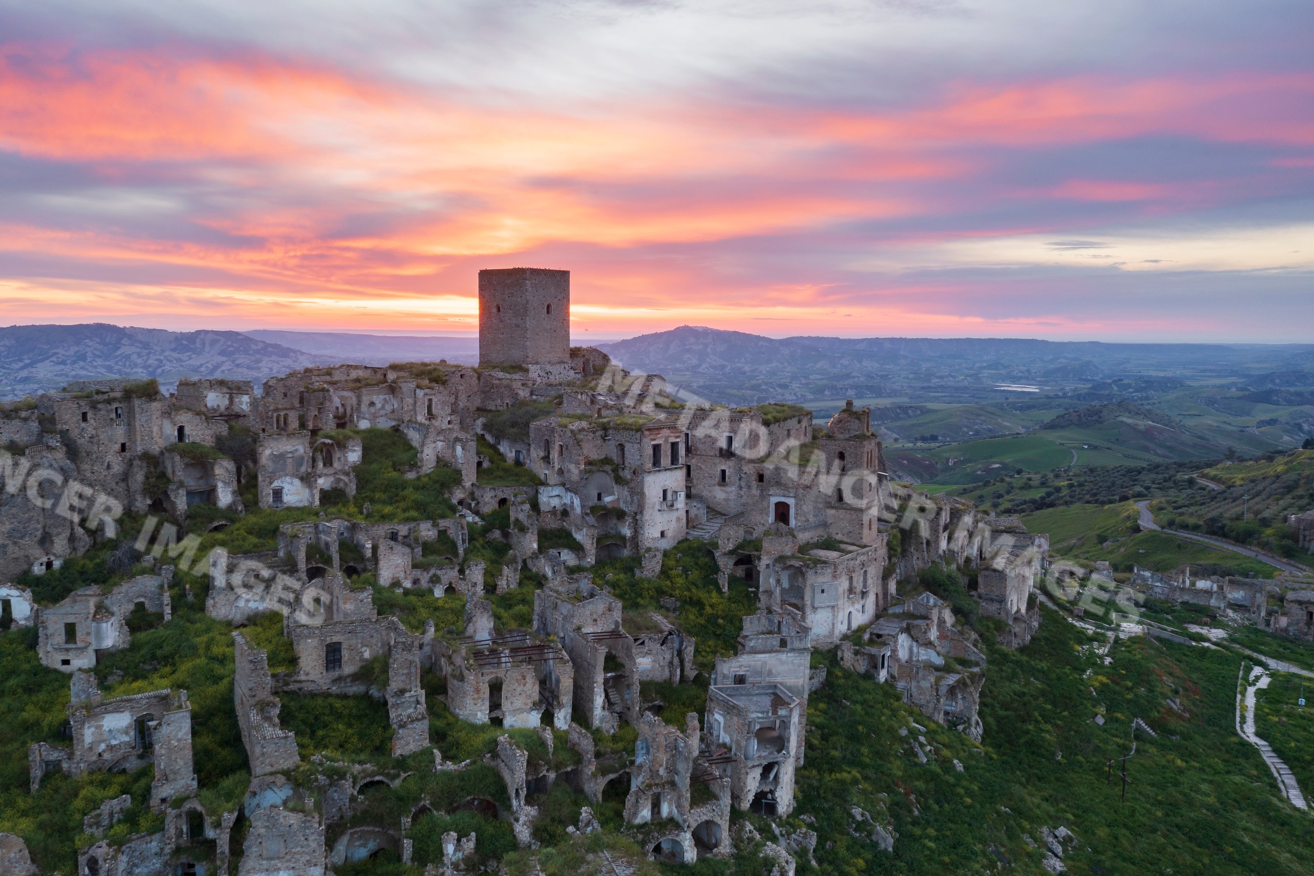 Ruined city of Craco on hillside at Sunrise in basilicata Italy