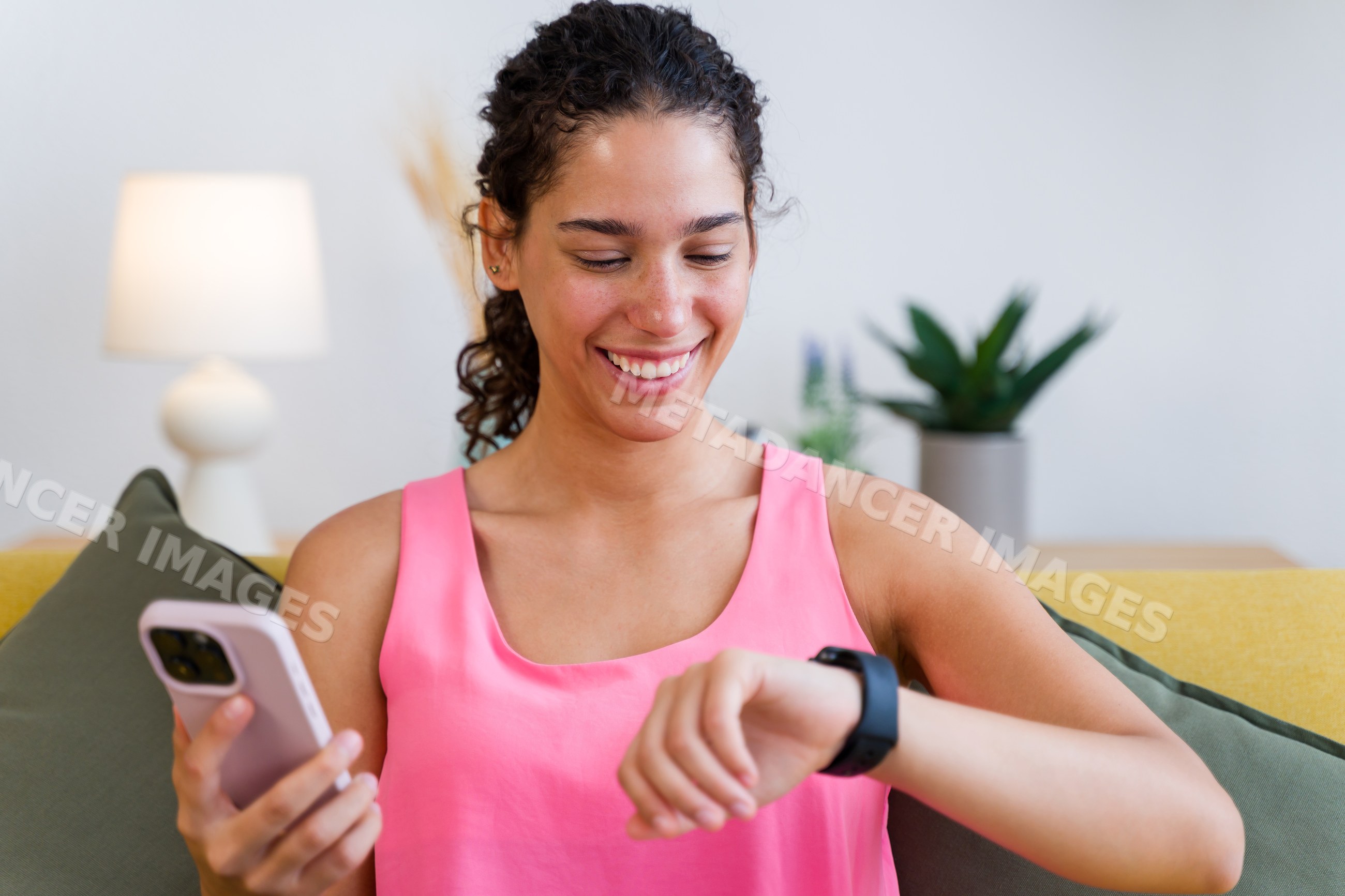 A Hispanic woman checks her watch