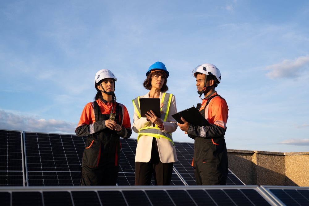 Engineers inspecting solar panel installation