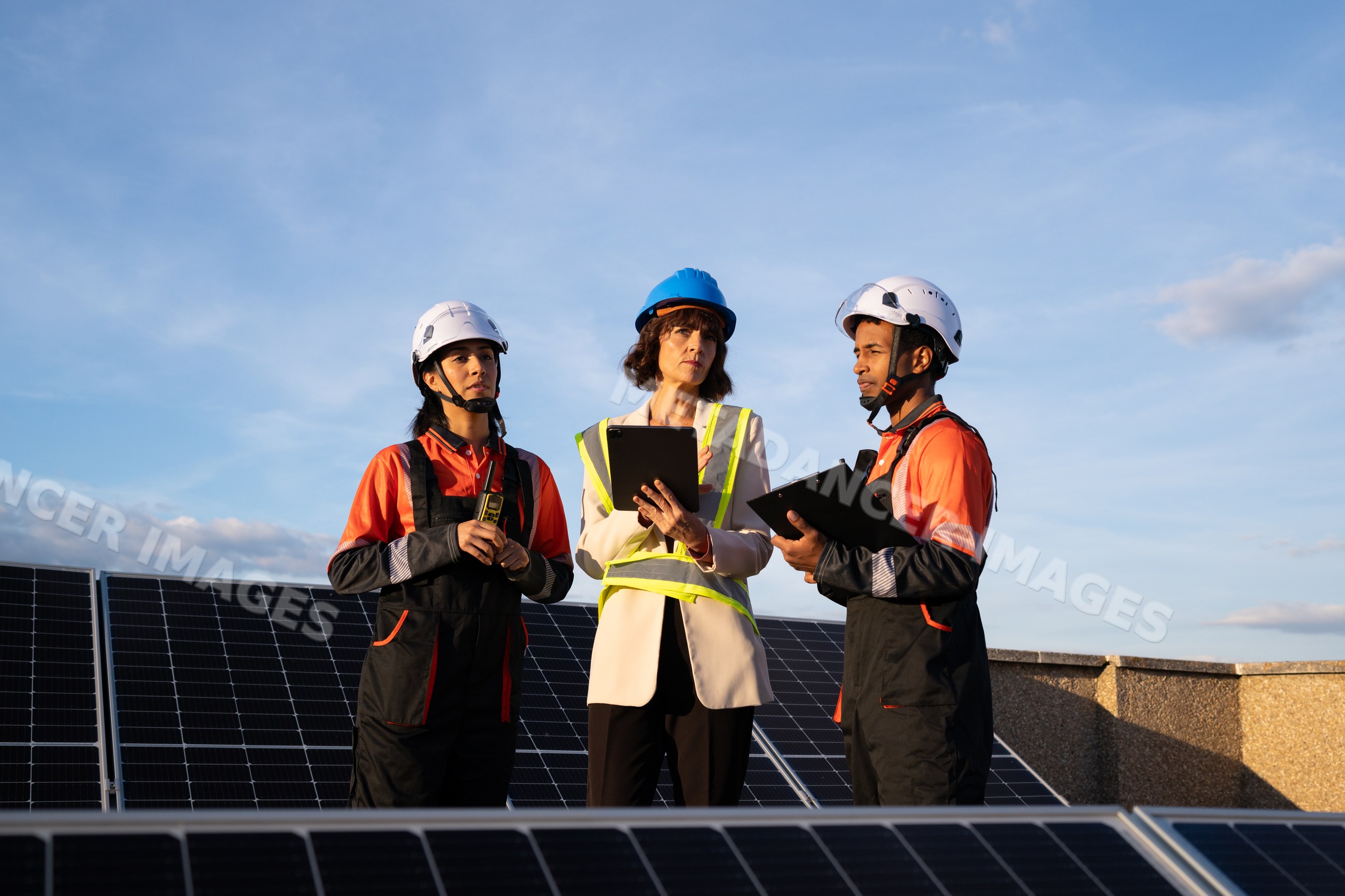 Engineers inspecting solar panel installation