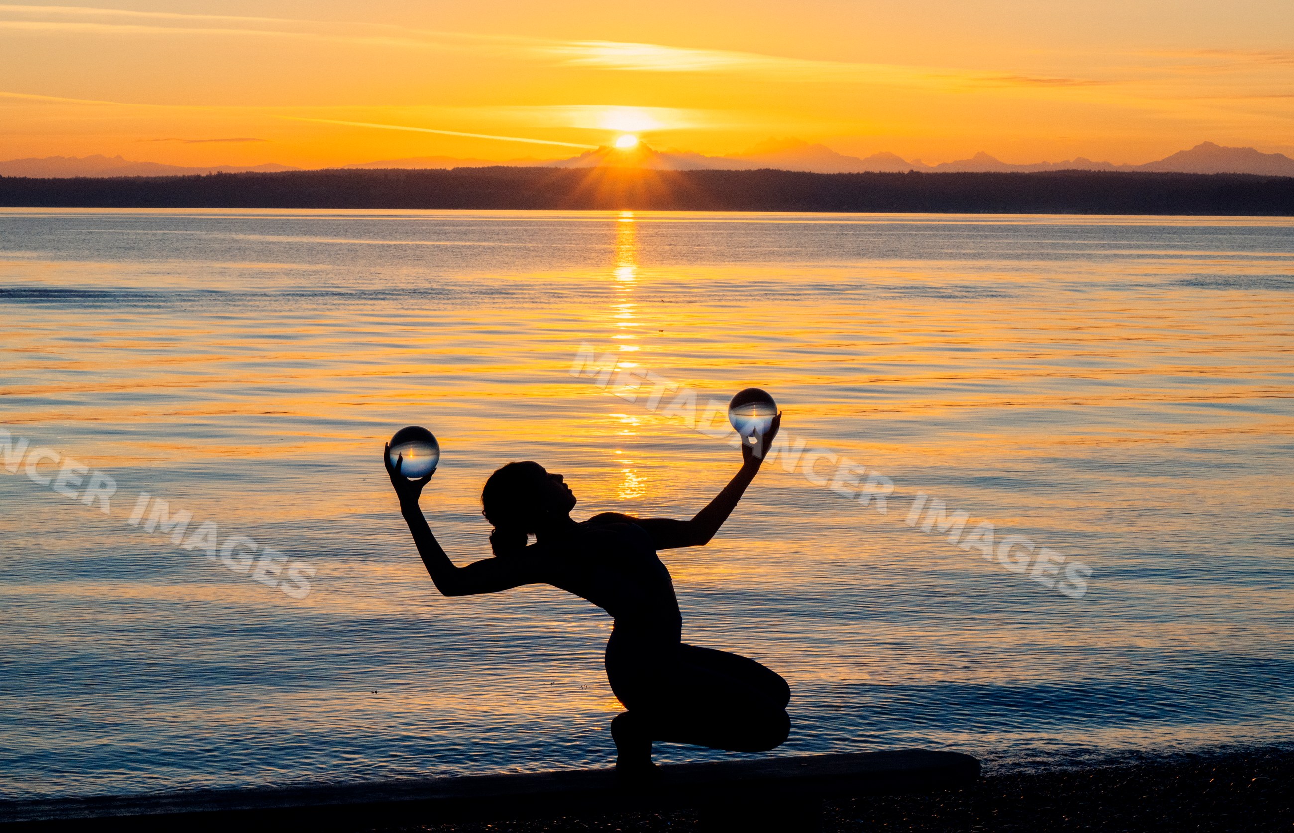Silhouette of Hispanic woman performing yoga acrobatic pose