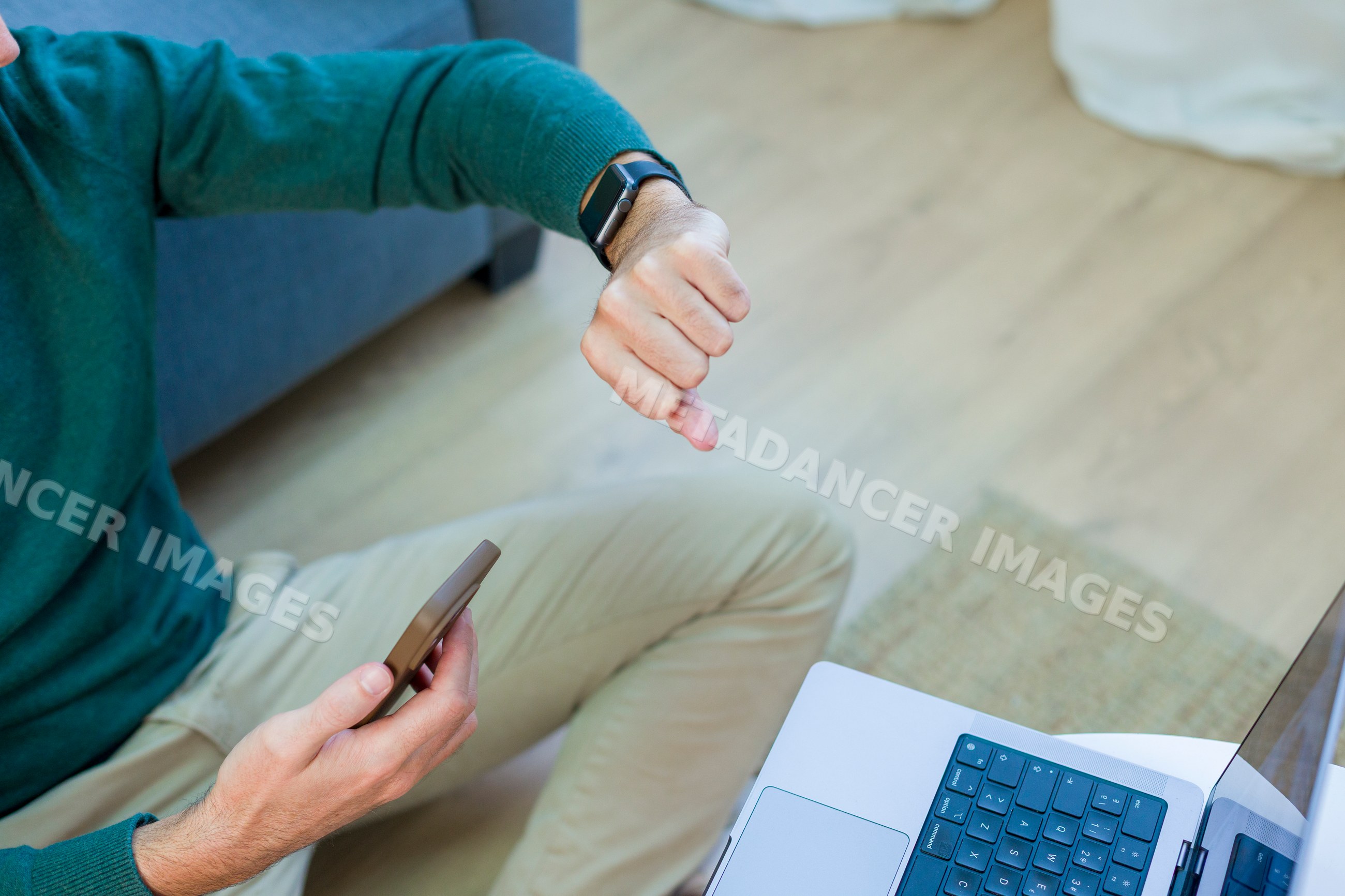 White man using smartphone and smartwatch