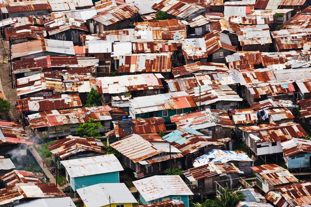 Dense cluster of houses with rusted metal roofs