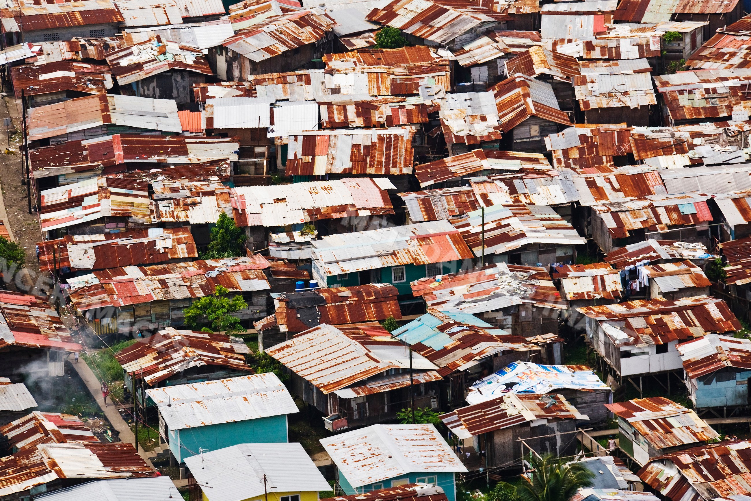 Dense cluster of houses with rusted metal roofs