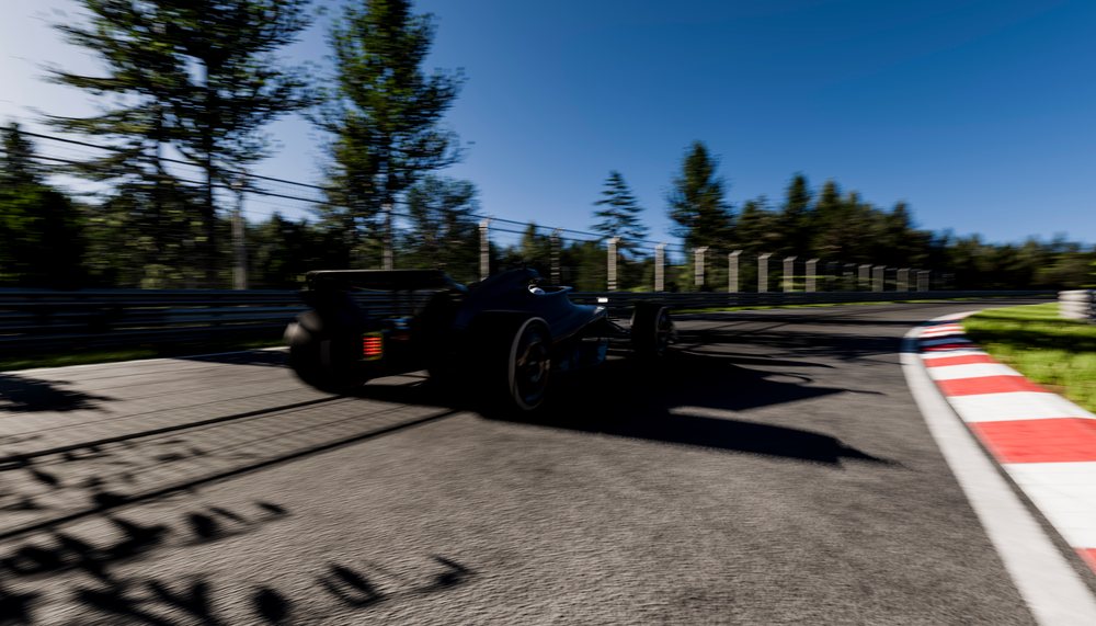 Black race car speeding around a curve on a racetrack