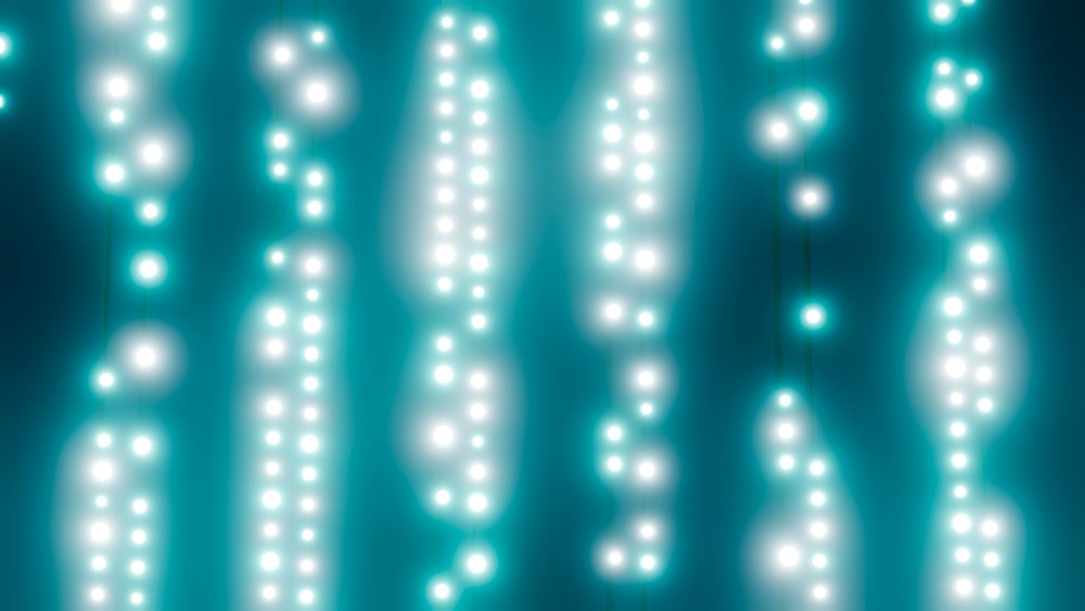 Glowing white string lights hanging against blue background