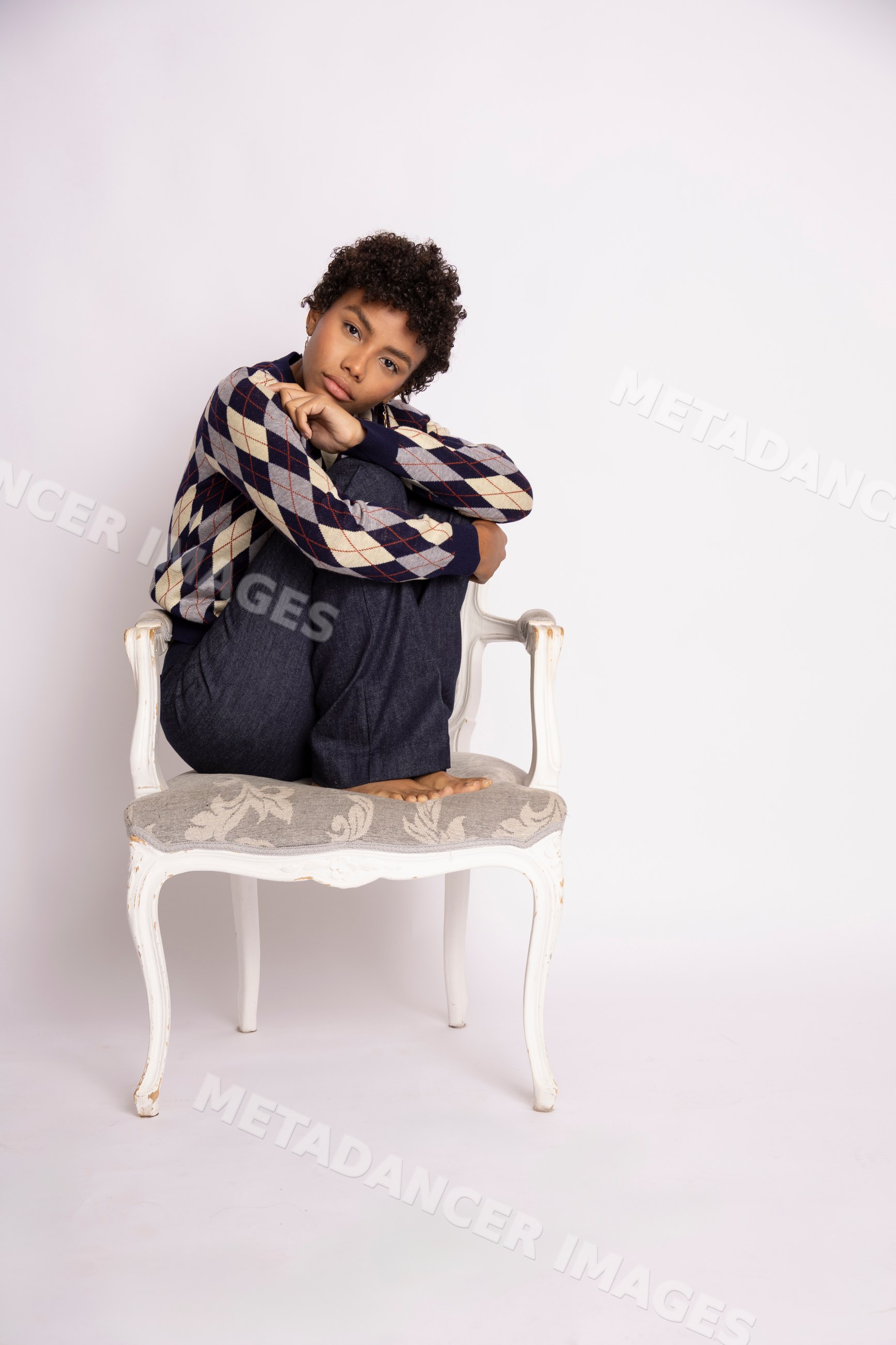 Young Hispanic woman sitting on armchair