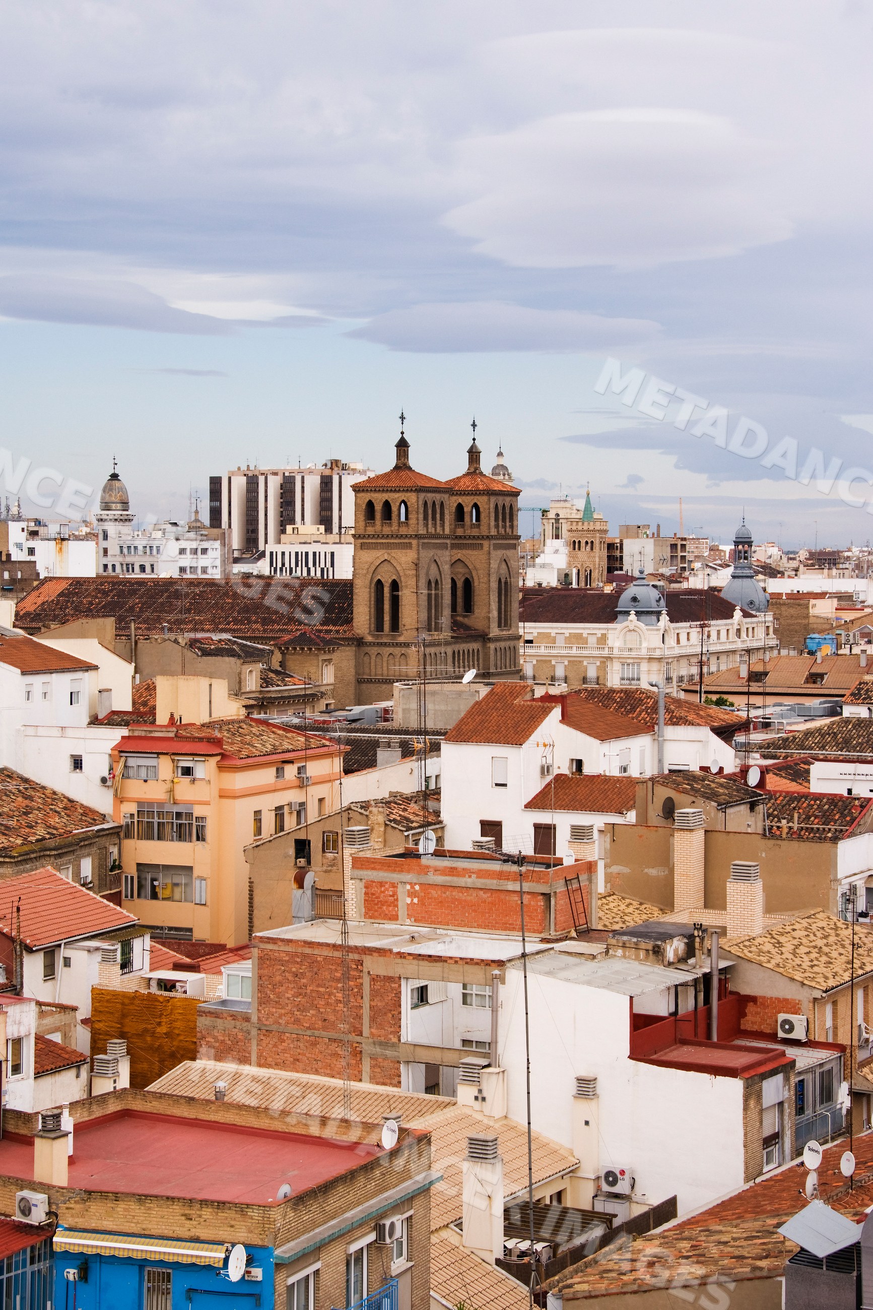 Cityscape of zaragoza with historic church tower and urban rooftops