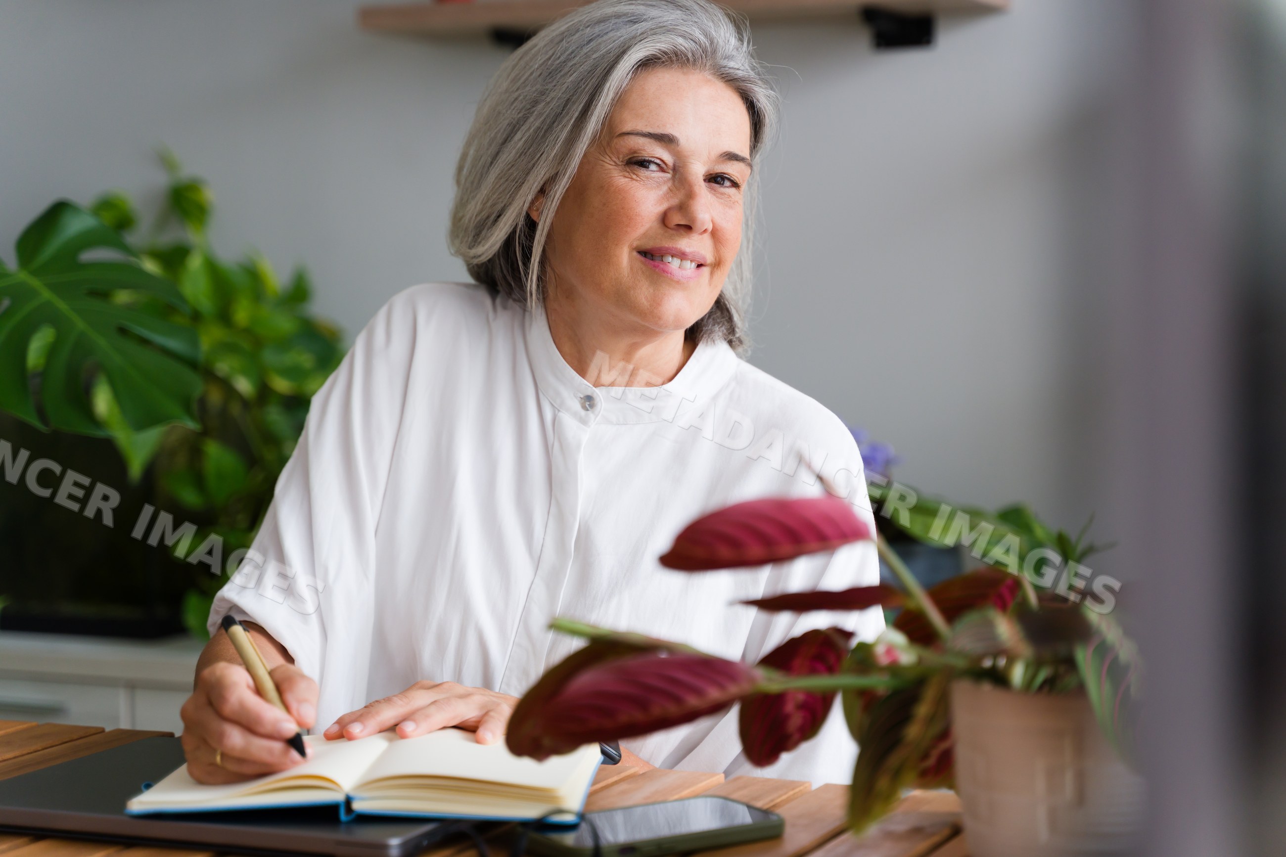 White Woman with gray hair writing