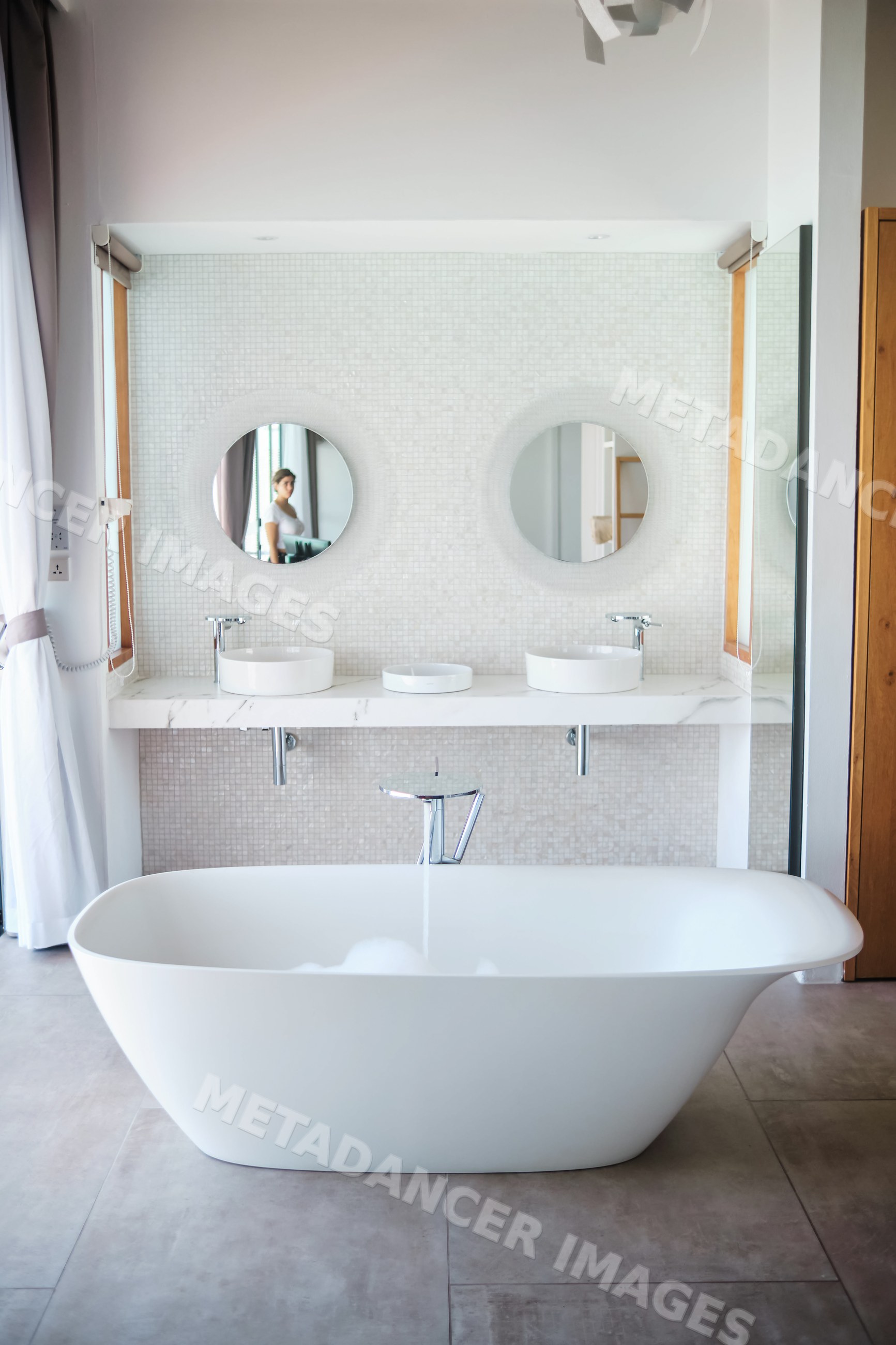 Modern bathroom with freestanding bathtub and double sinks