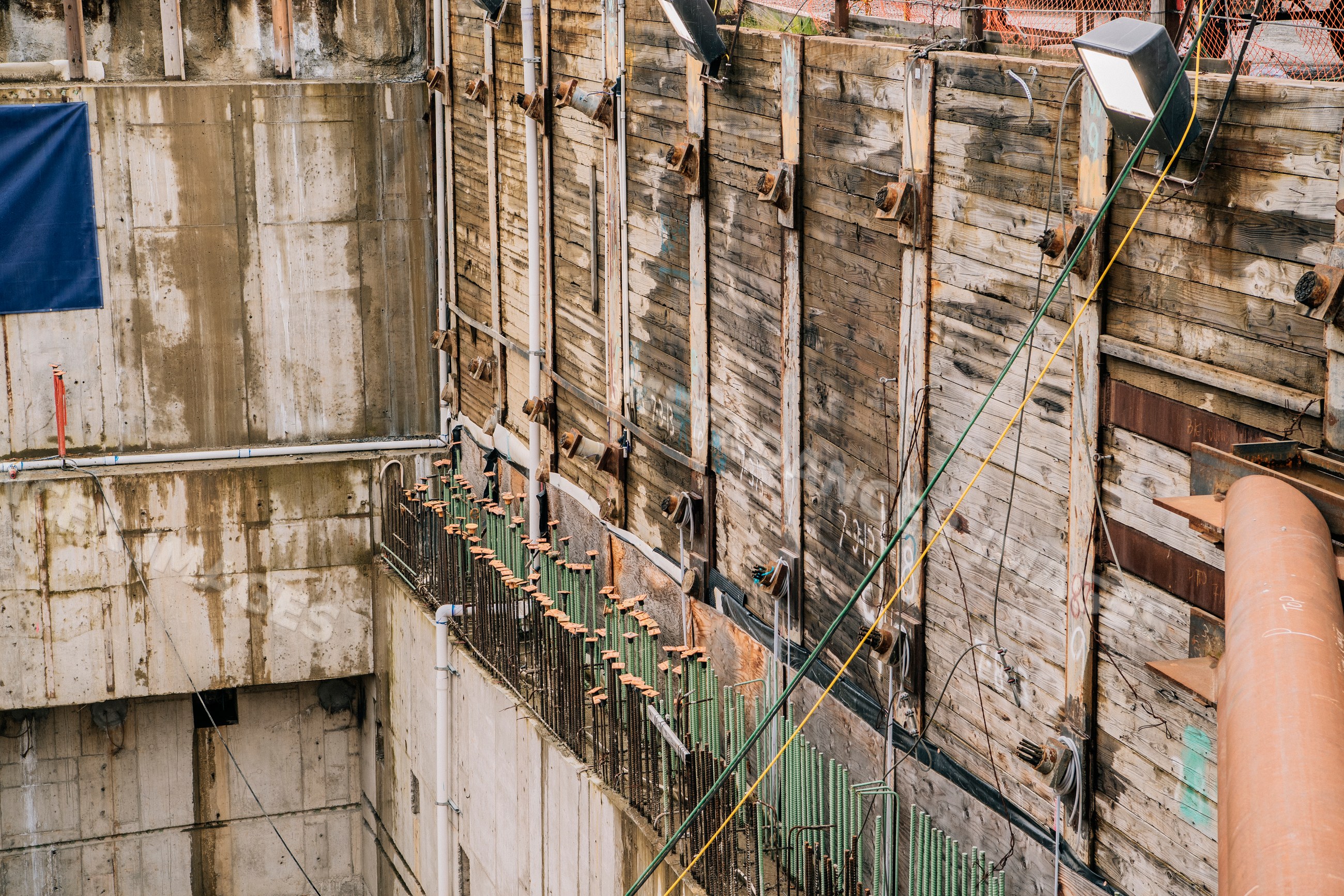 Construction site with reinforced concrete and wooden retaining walls
