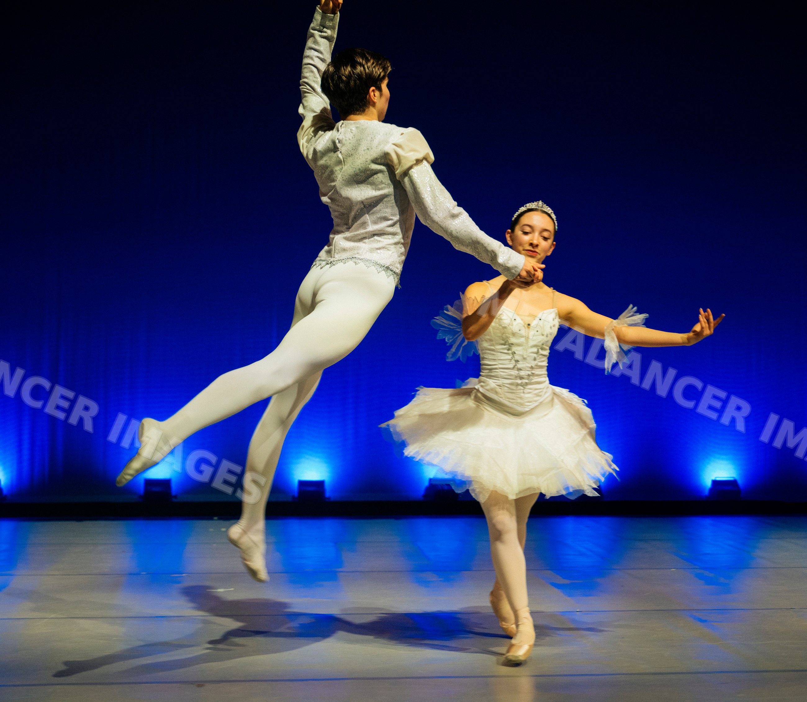Two ballet dancers perform a graceful dance routine on stage
