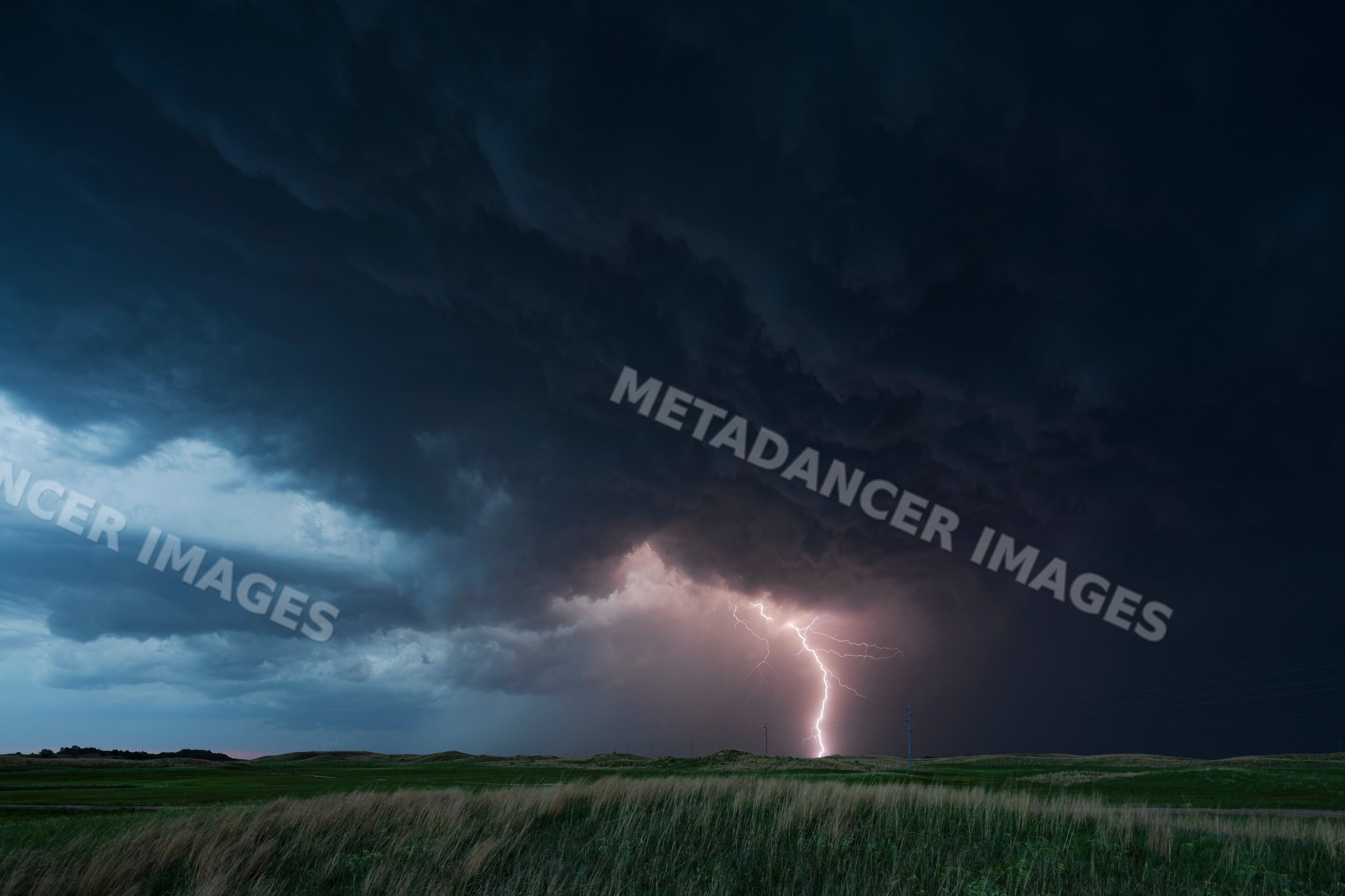 Lightning striking during stormy Blue Hour in Nebraska Sandhills