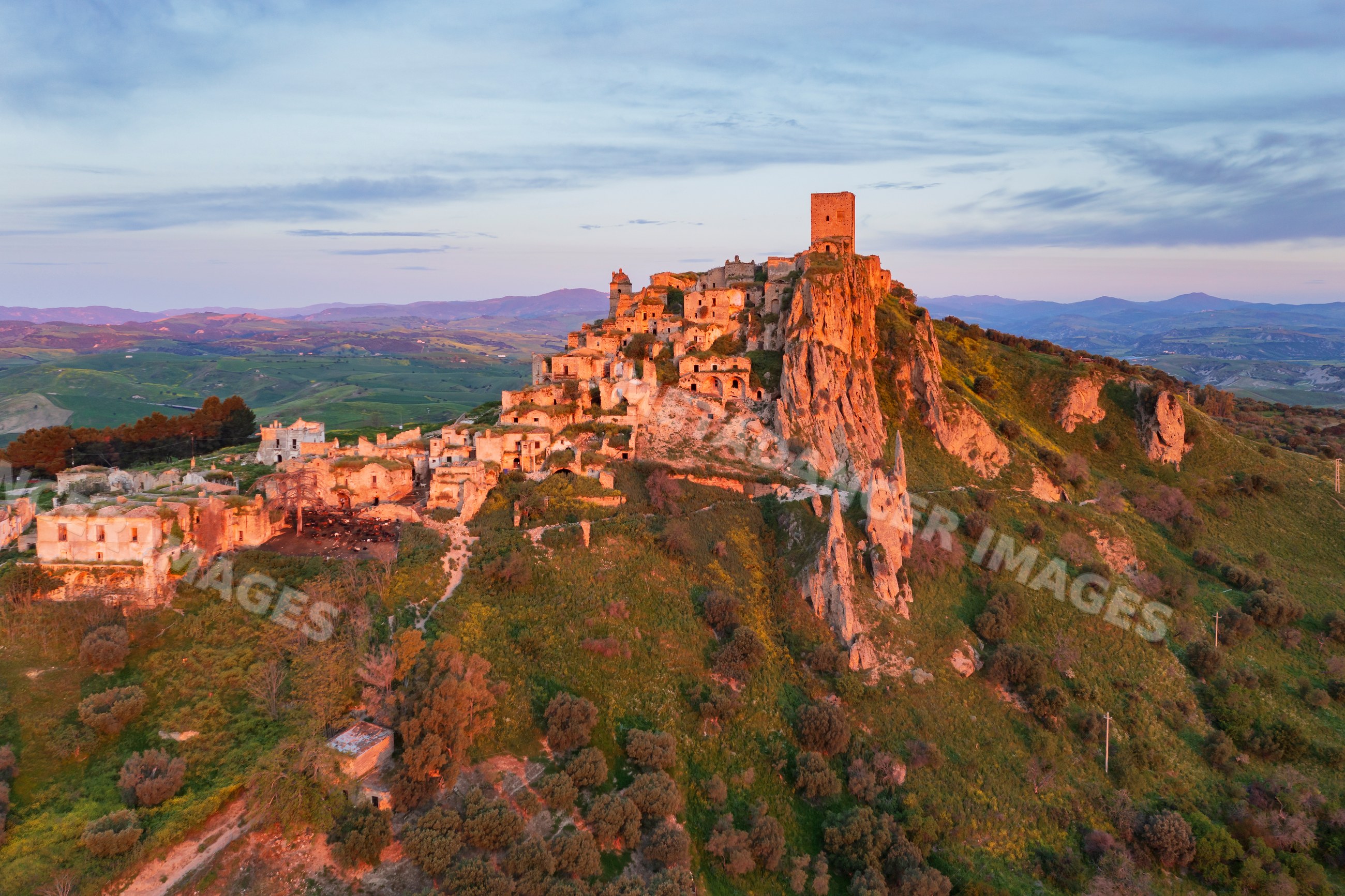 Ruined city of Craco on hilltop at Sunrise in basilicata Italy