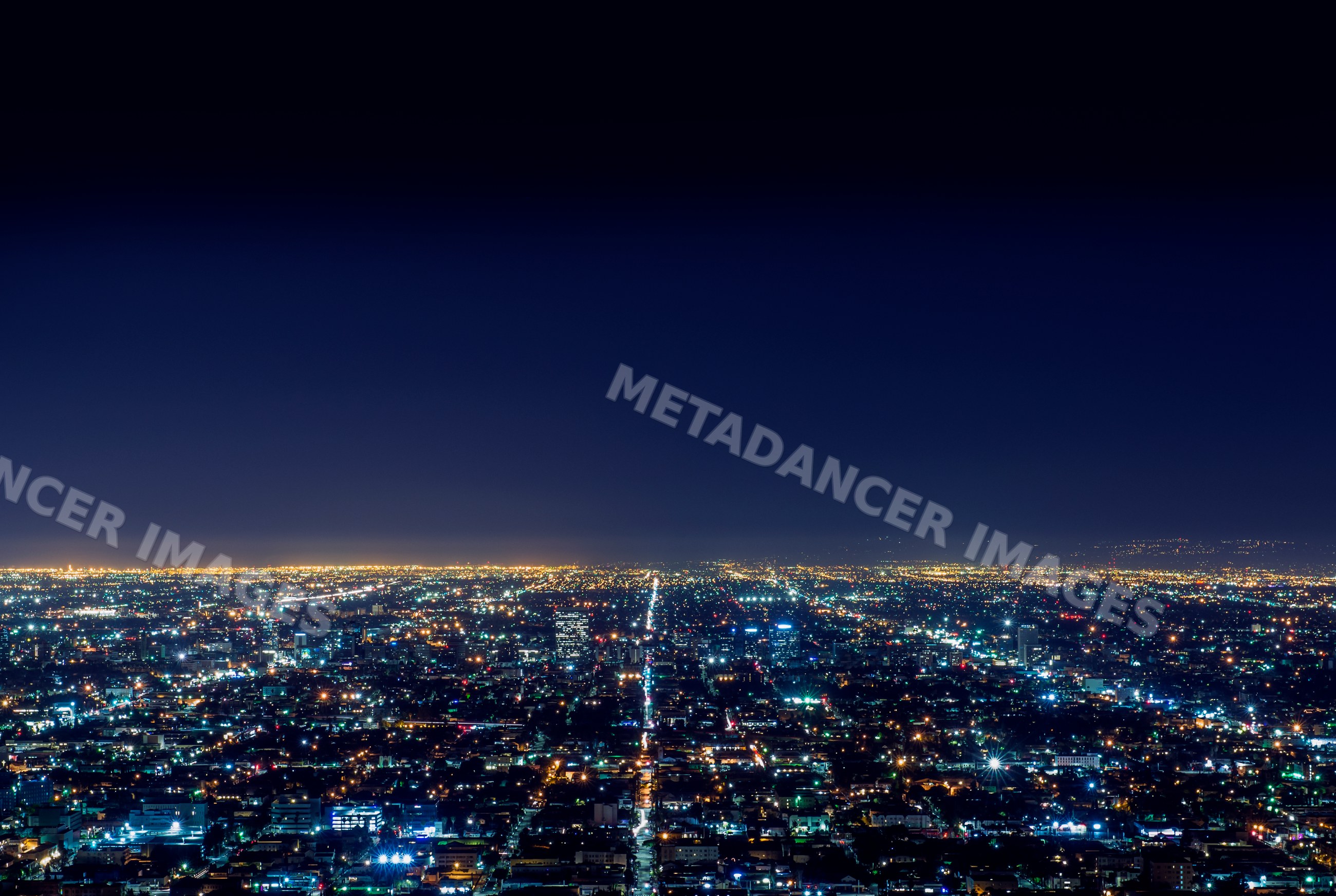 Los Angeles cityscape illuminated at night with aerial view