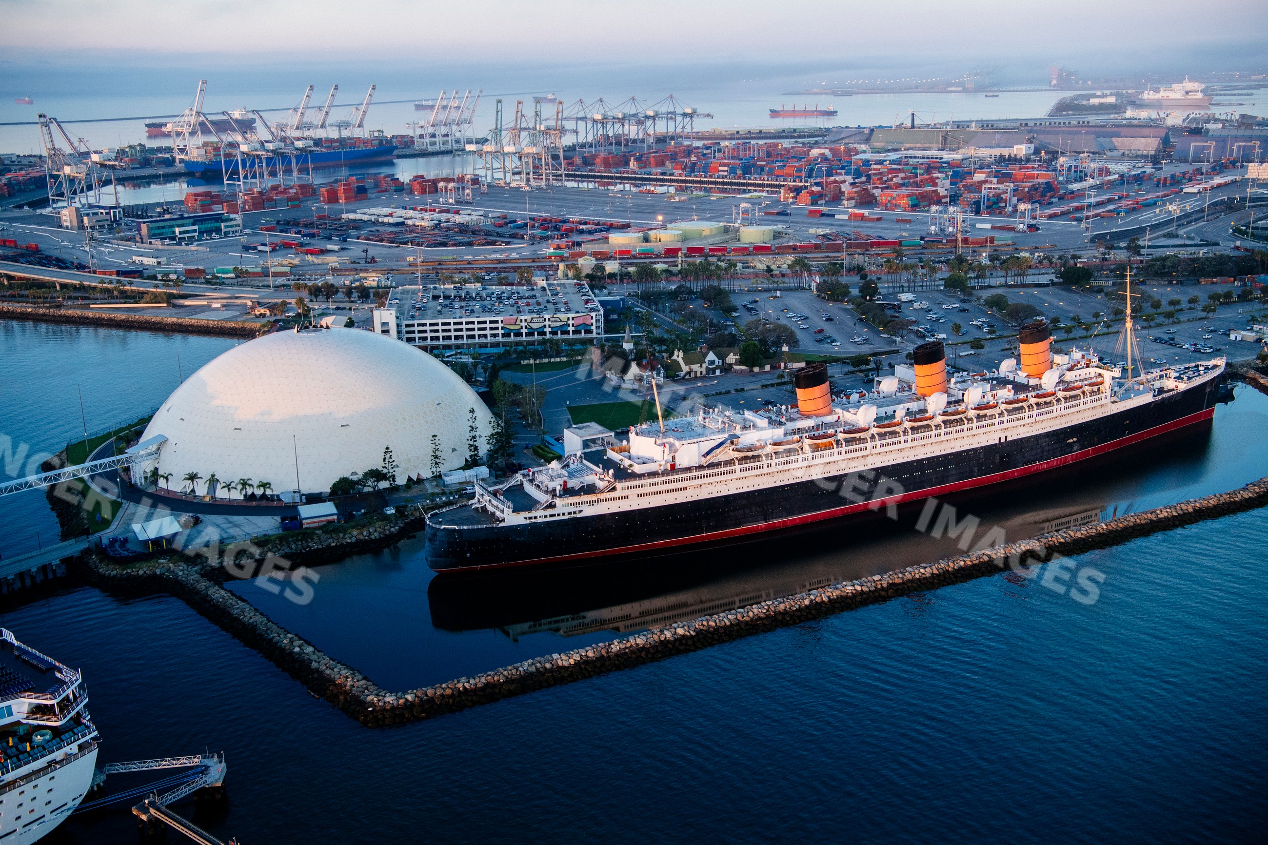 Historic ocean liner docked at the busy port of Long Beach, CA, USA