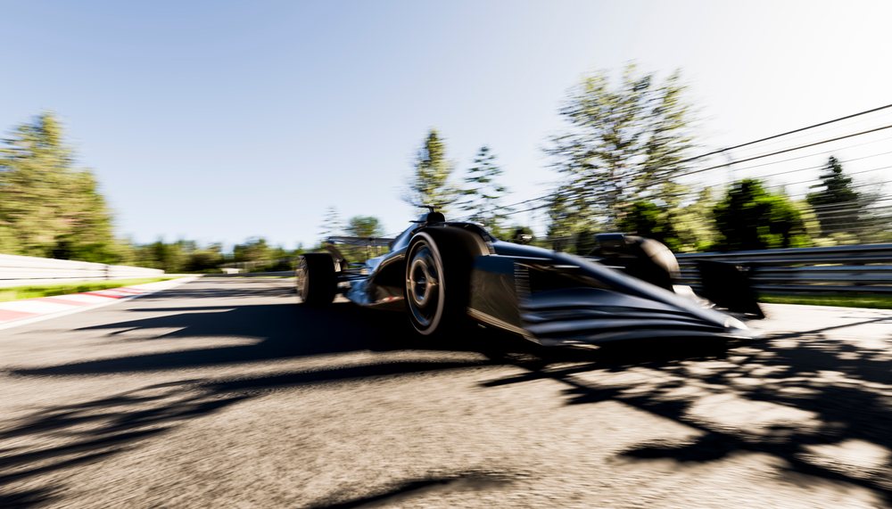 Racing car speeding on an outdoor race track in sunlight