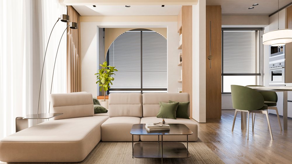 Modern living room with beige sectional sofa and green pillows