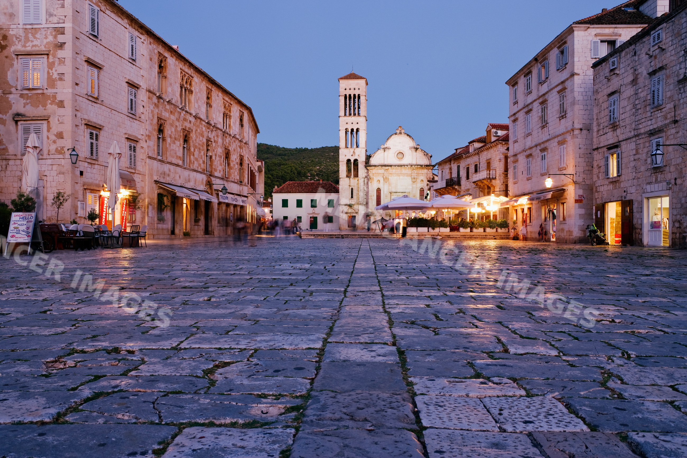 Stone paved square with church tower, croatia