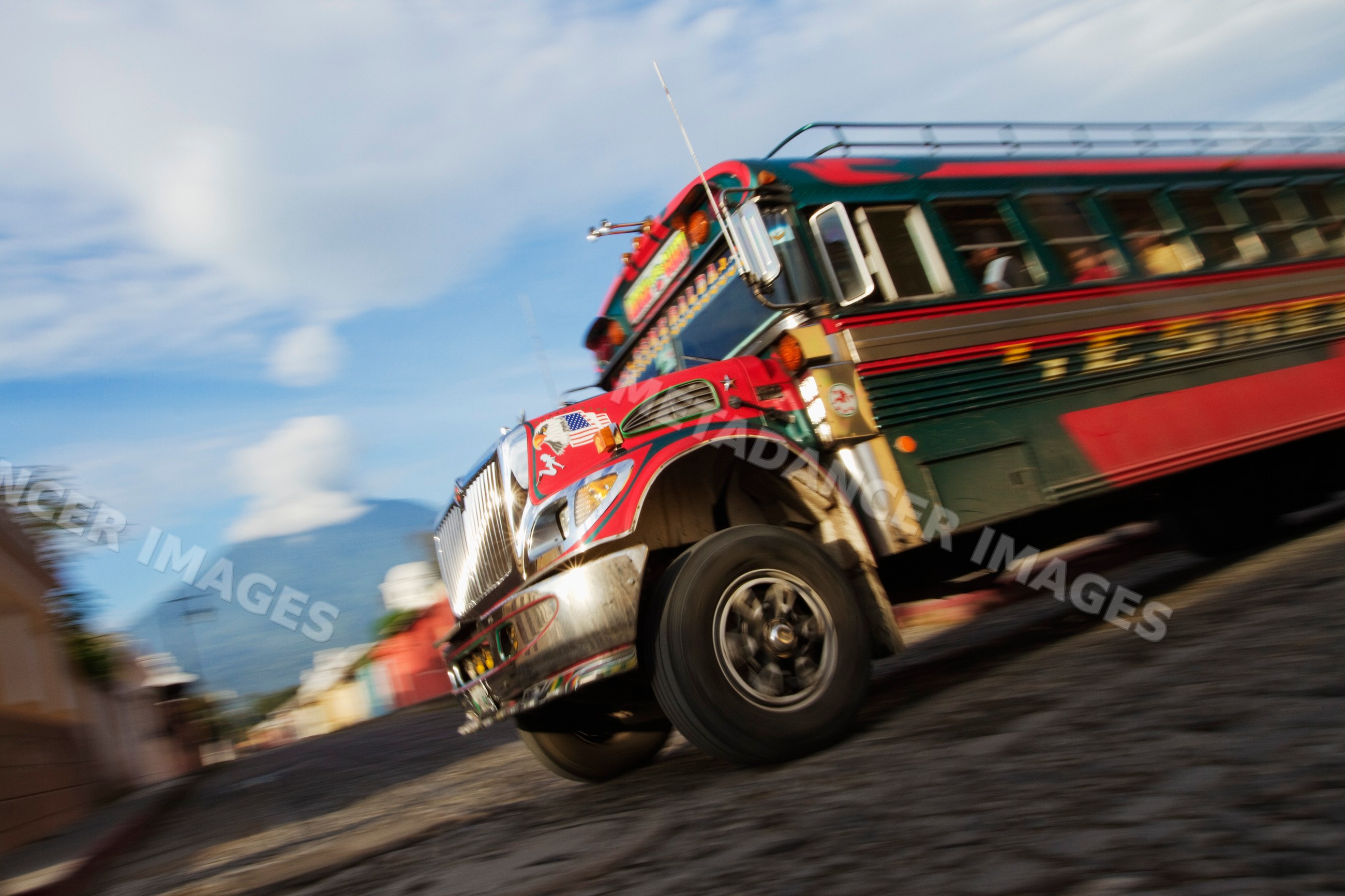 Colorful chicken bus driving through sacatepequez department guatemala