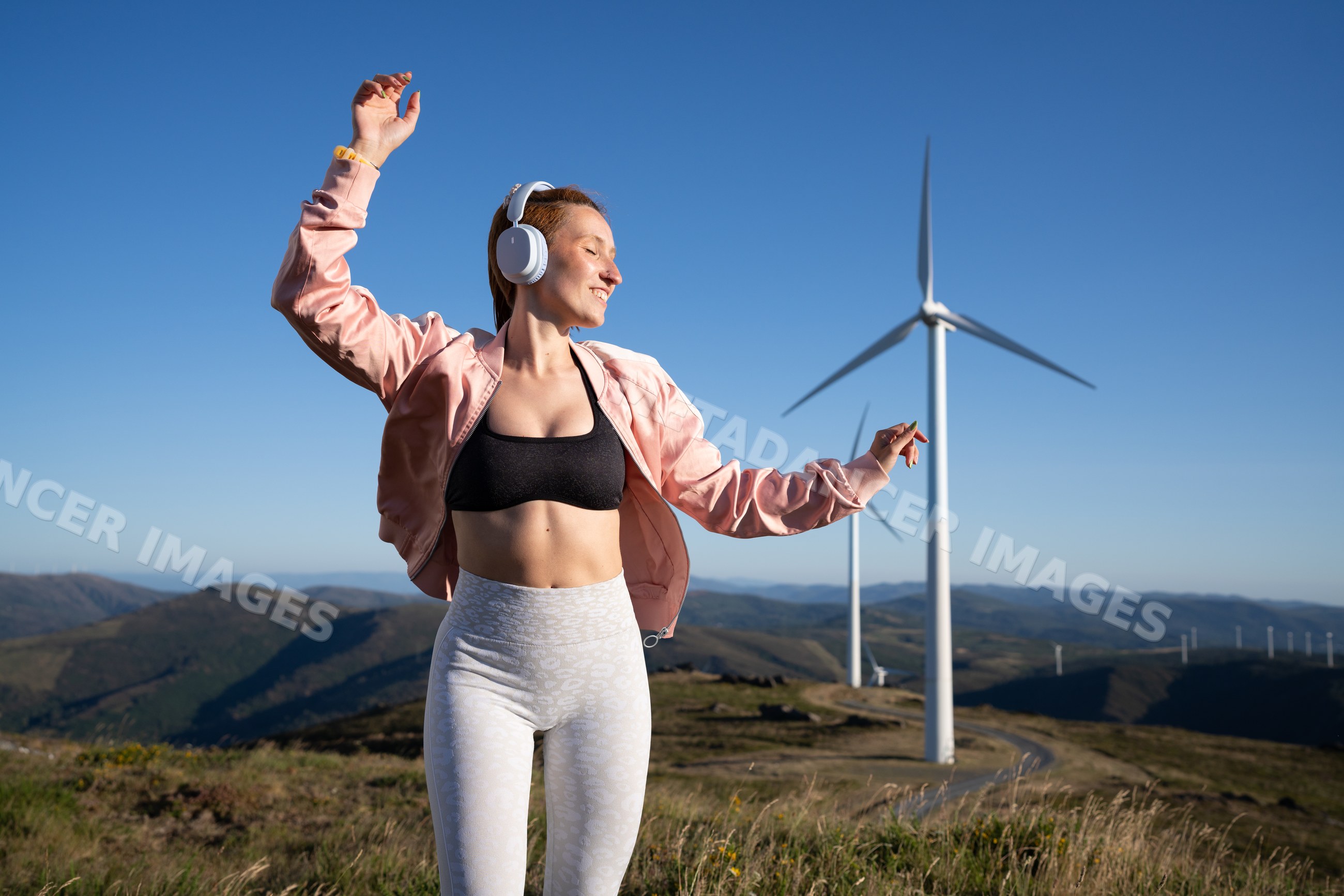 A white woman enjoying music