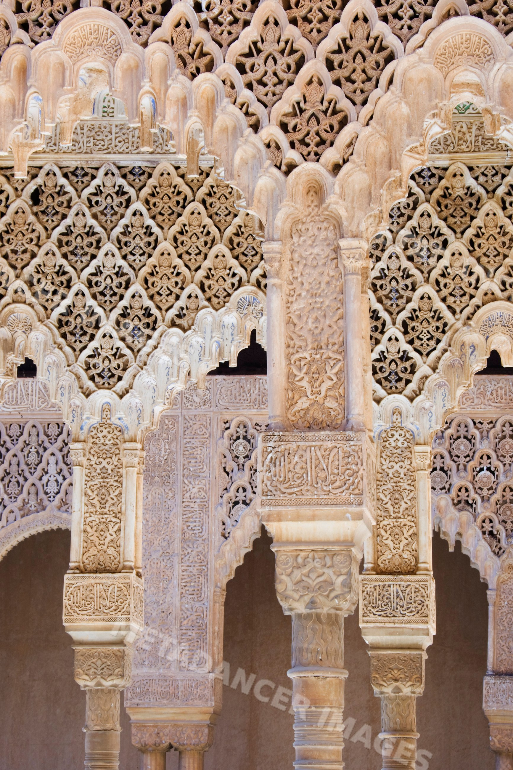 Ornate stone arches and columns at alhambra palace Spain