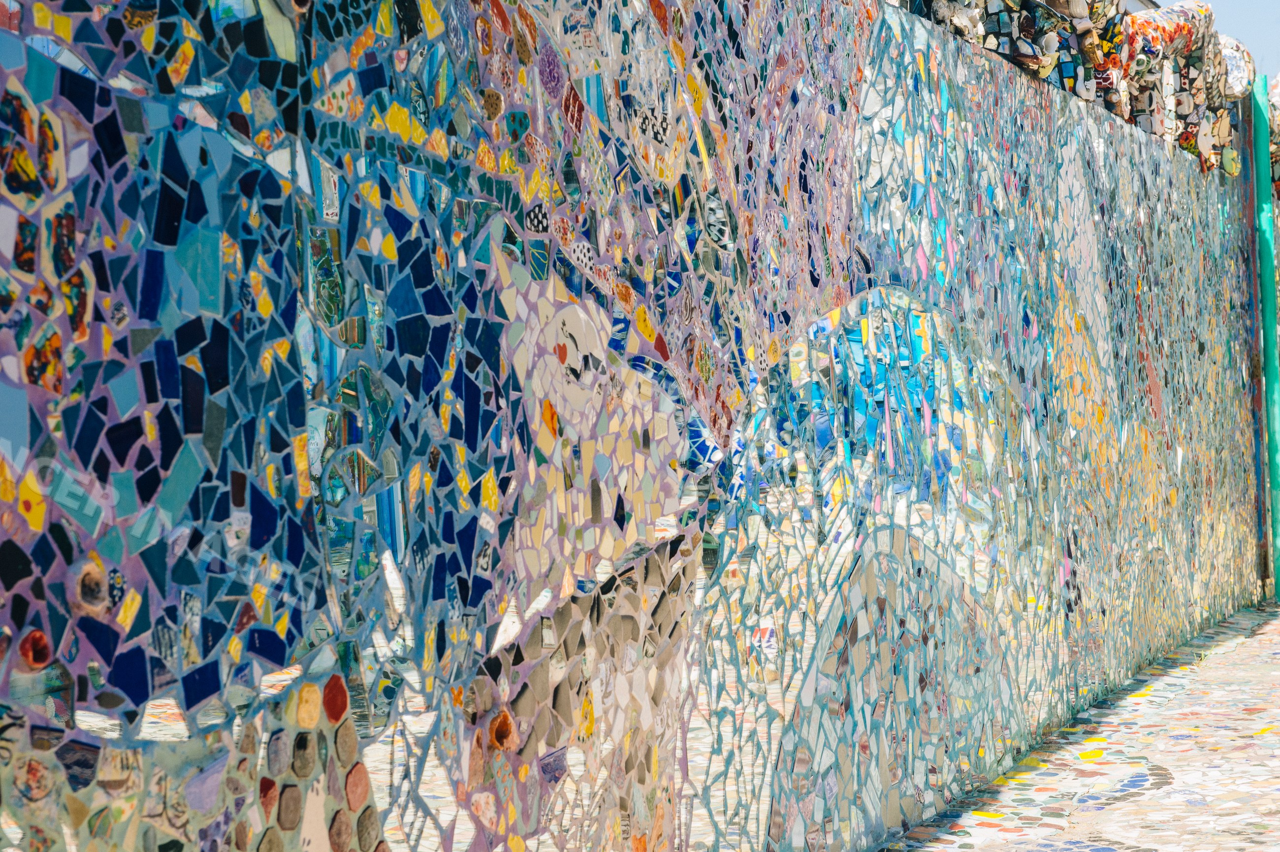 Colorful mosaic wall artwork with intricate tile patterns outdoors