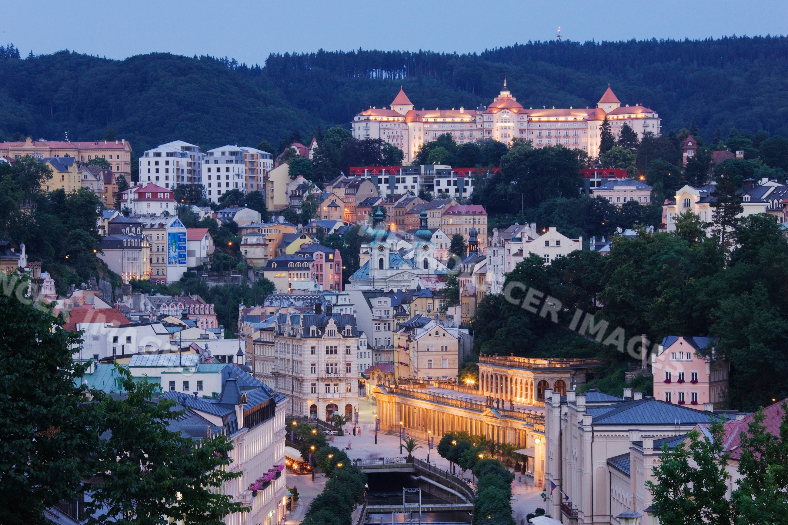Karlovy vary cityscape with castle on hill at evening czech republic