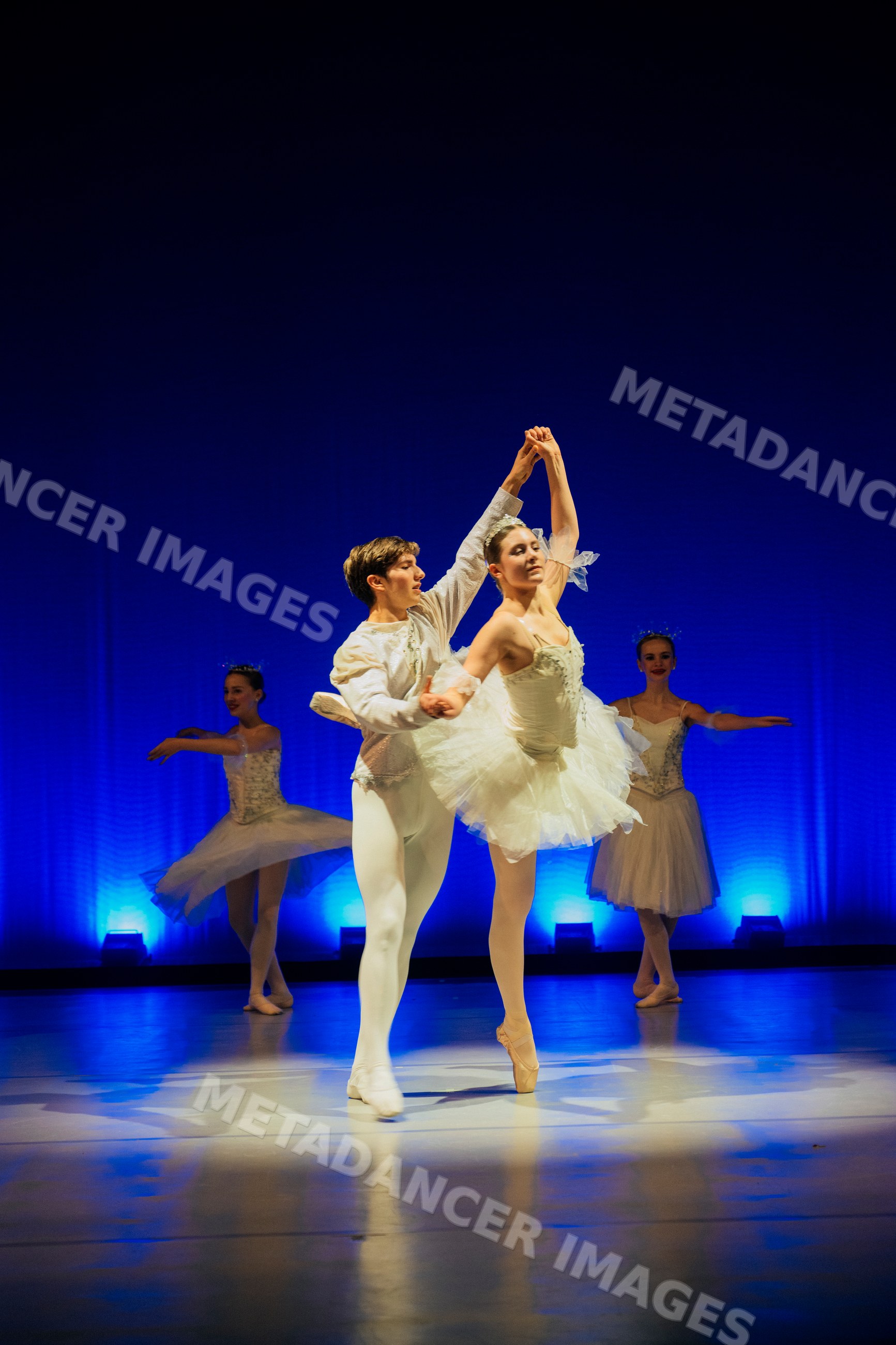 Ballet dancers performing a partnered dance during a holiday-themed