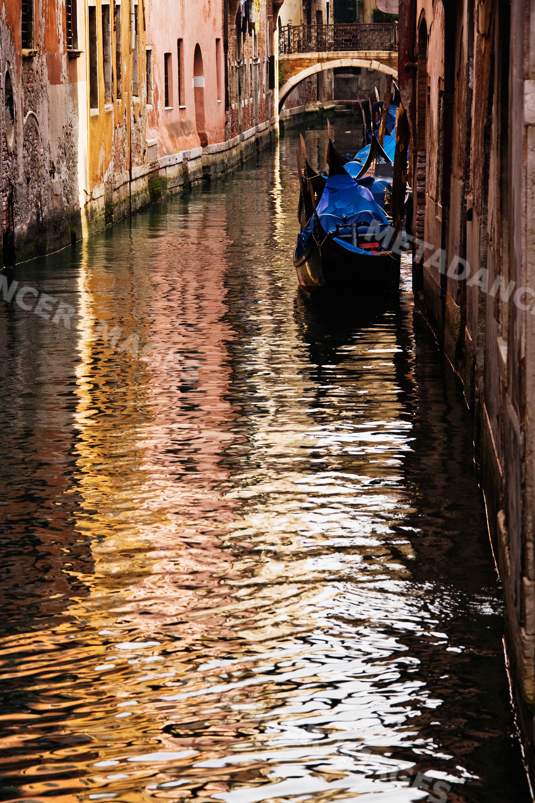 Gondolas moored on a canal in venice, veneto, italy