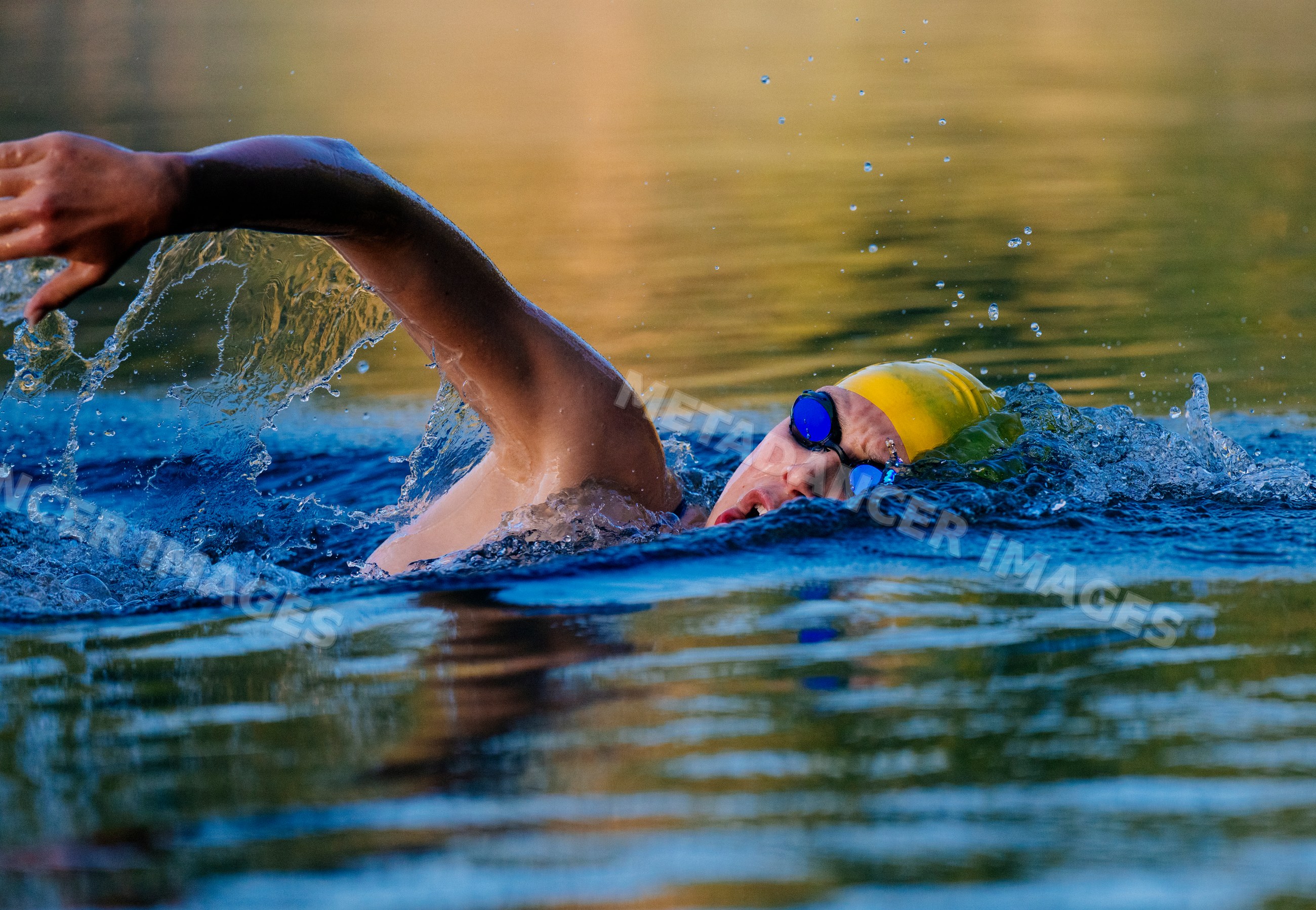 White swimmer performing freestyle stroke in open water