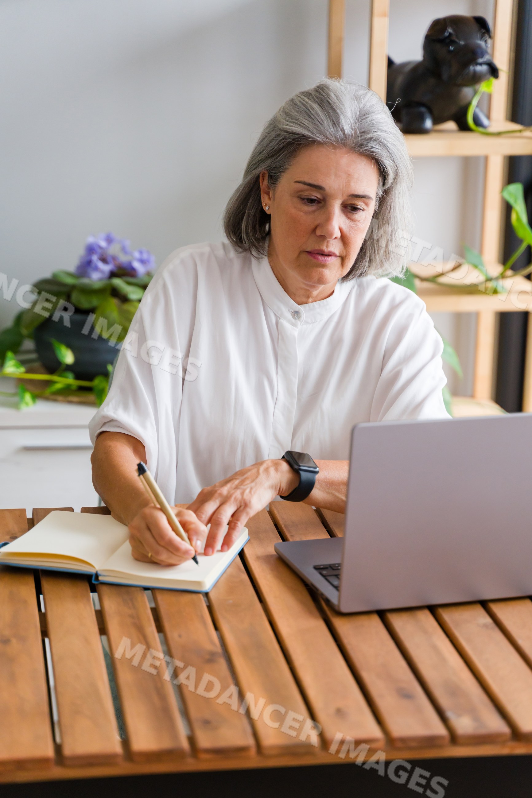 Middle-aged white woman writing notes in a notebook