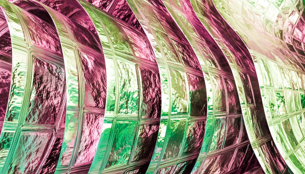 Curved decorative glass block wall with colorful textured surfaces