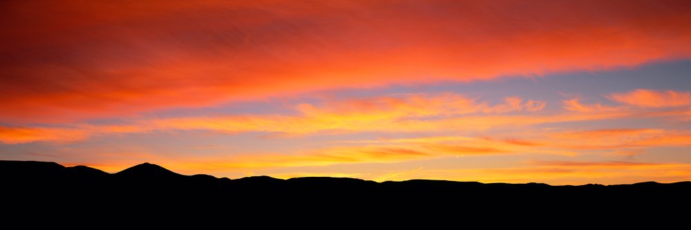 Sunrise over silhouette of mountain landscape with colorful sky
