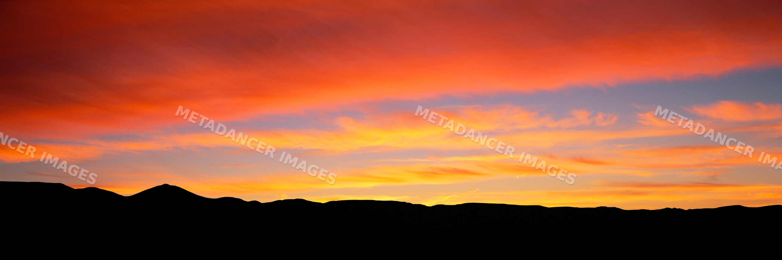 Sunrise over silhouette of mountain landscape with colorful sky