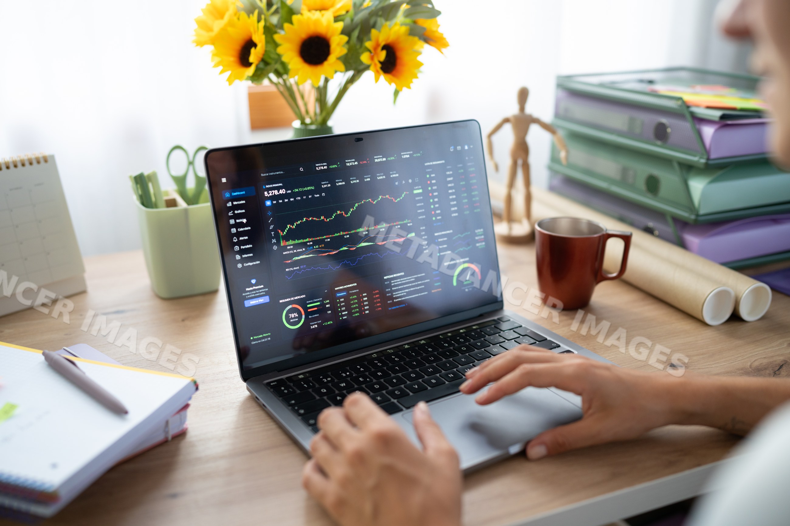 A white person analyzing stock market data on a laptop