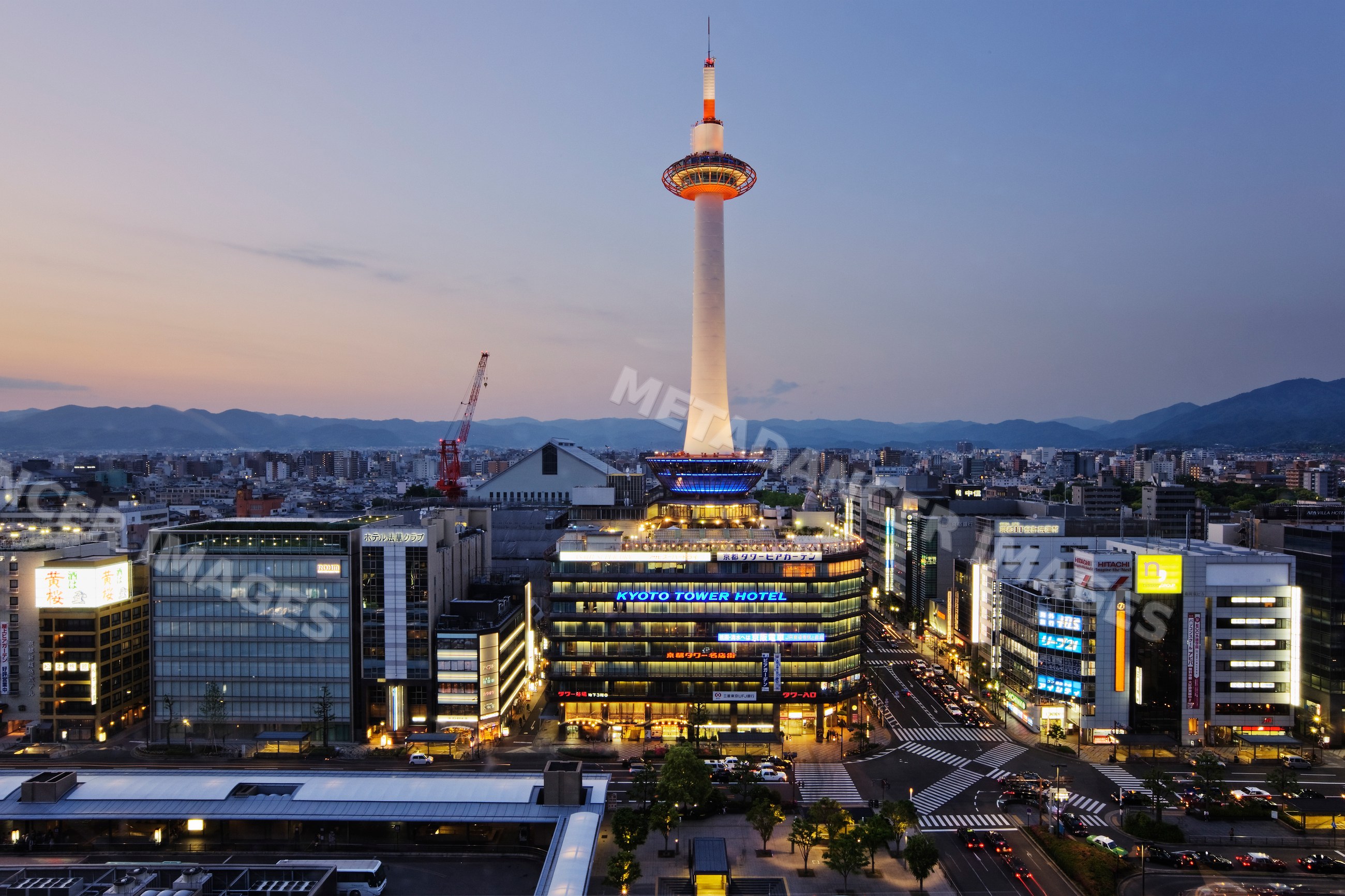 Kyoto tower illuminated over the cityscape of kyoto japan