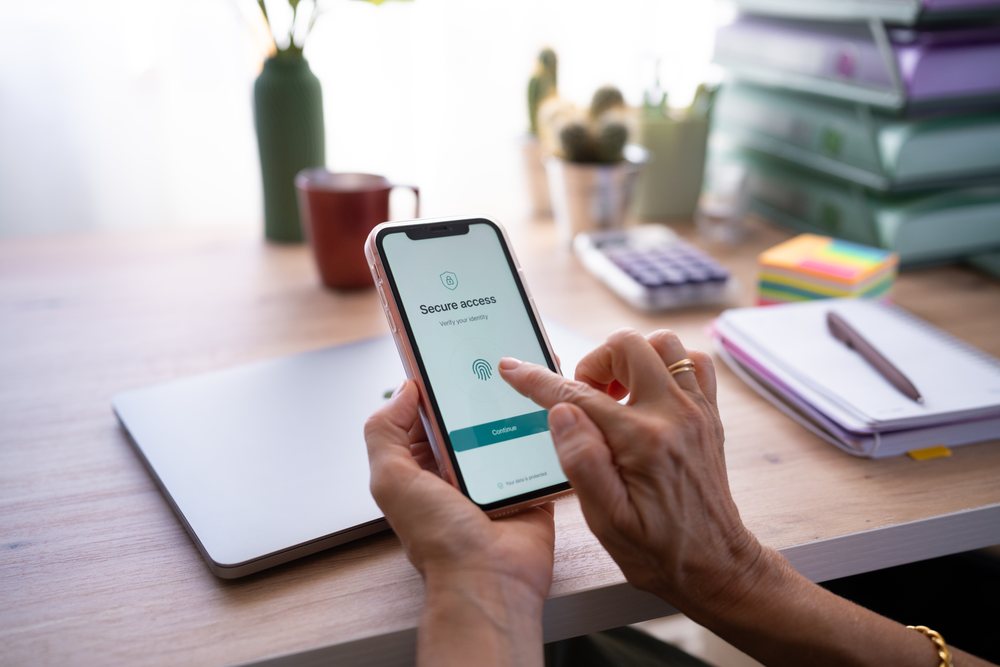 Hand using fingerprint authentication on smartphone