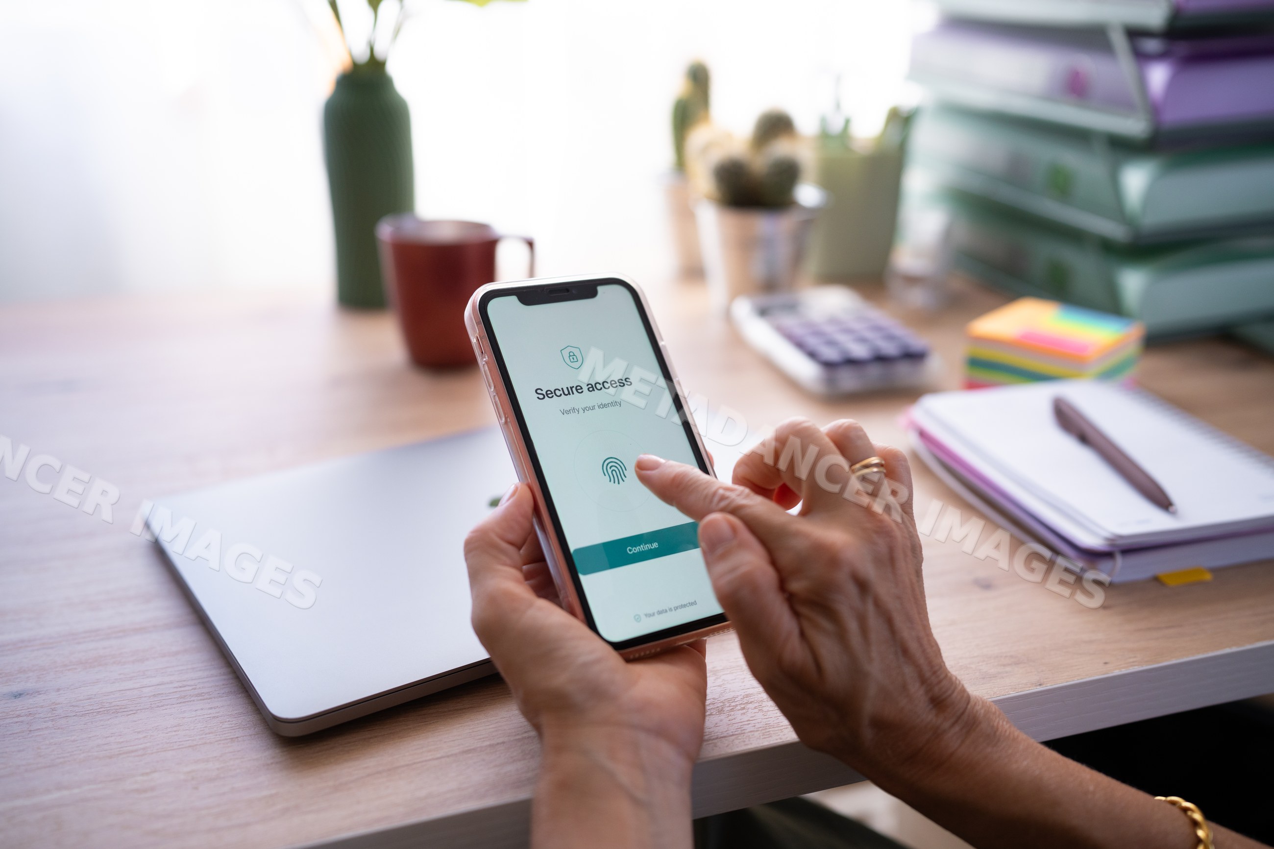 Hand using fingerprint authentication on smartphone