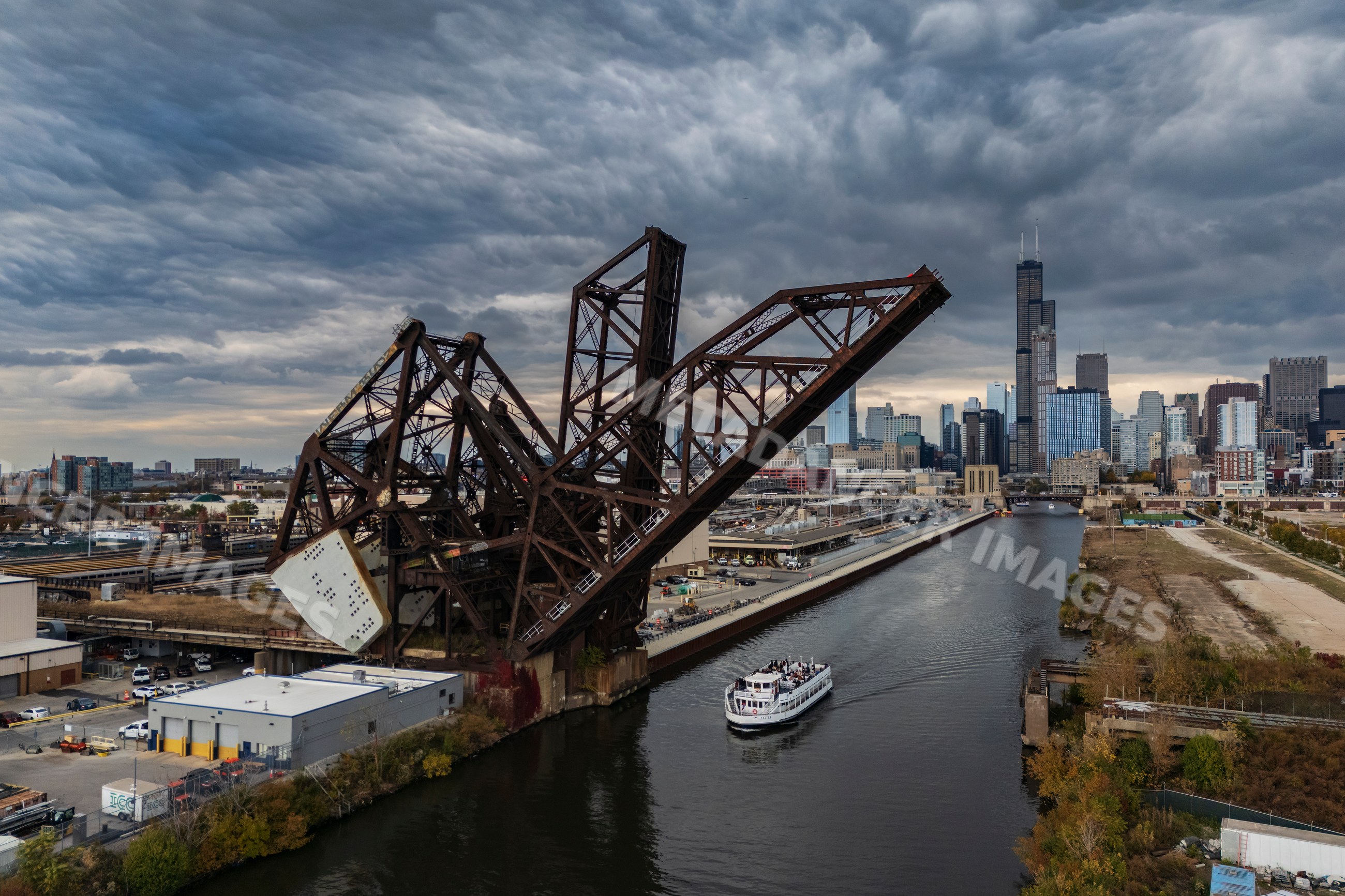 Cantilever Bridge raised on Chicago River with boat and city skyline