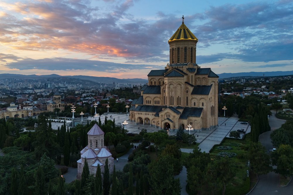 Holy trinity cathedral of Tbilisi at Sunset with city skyline